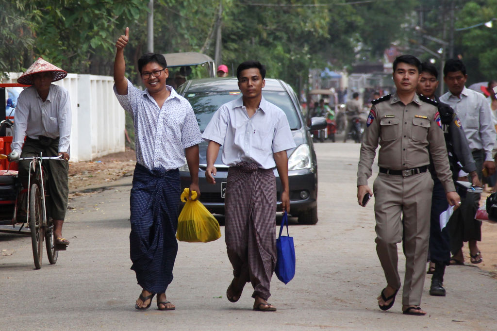Reuters journalists Wa Lone (center L) and Kyaw Soe Oo (center R) gesture outside Insein prison after being freed in a presidential amnesty in Yangon on May 7, 2019. (-&mdash;AFP/Getty Images)