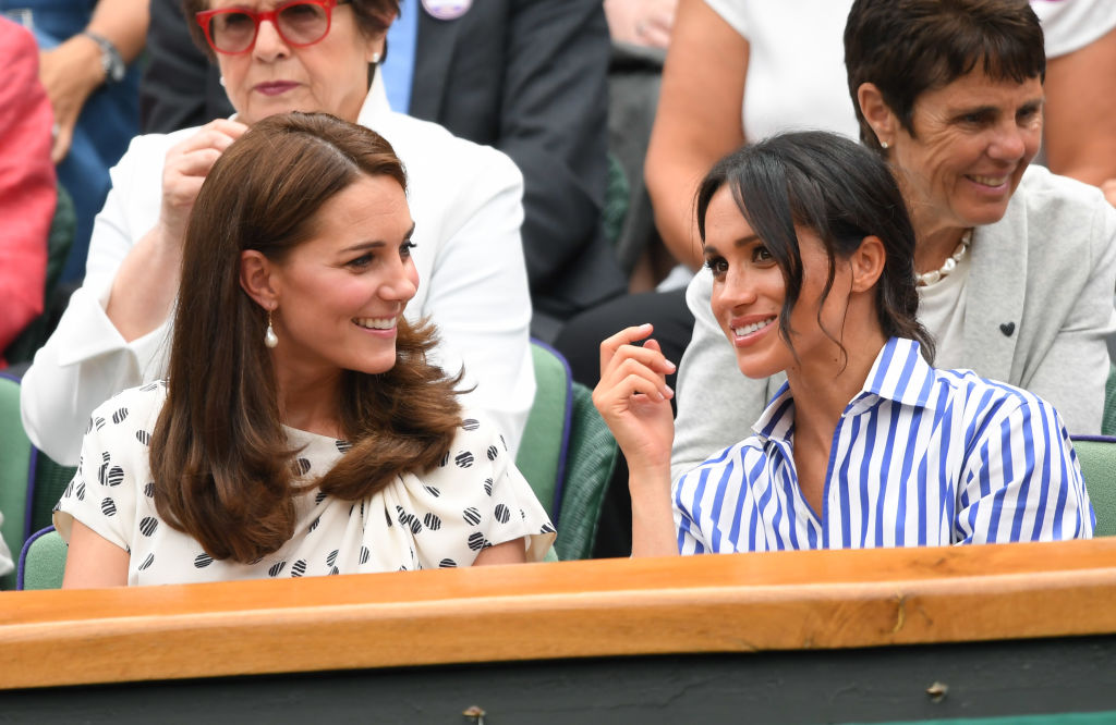 Catherine, Duchess of Cambridge and Meghan, Duchess of Sussex attend day twelve of the Wimbledon Tennis Championships at the All England Lawn Tennis and Croquet Club on July 14, 2018 in London, England. (Karwai Tang—WireImage/Getty Images)