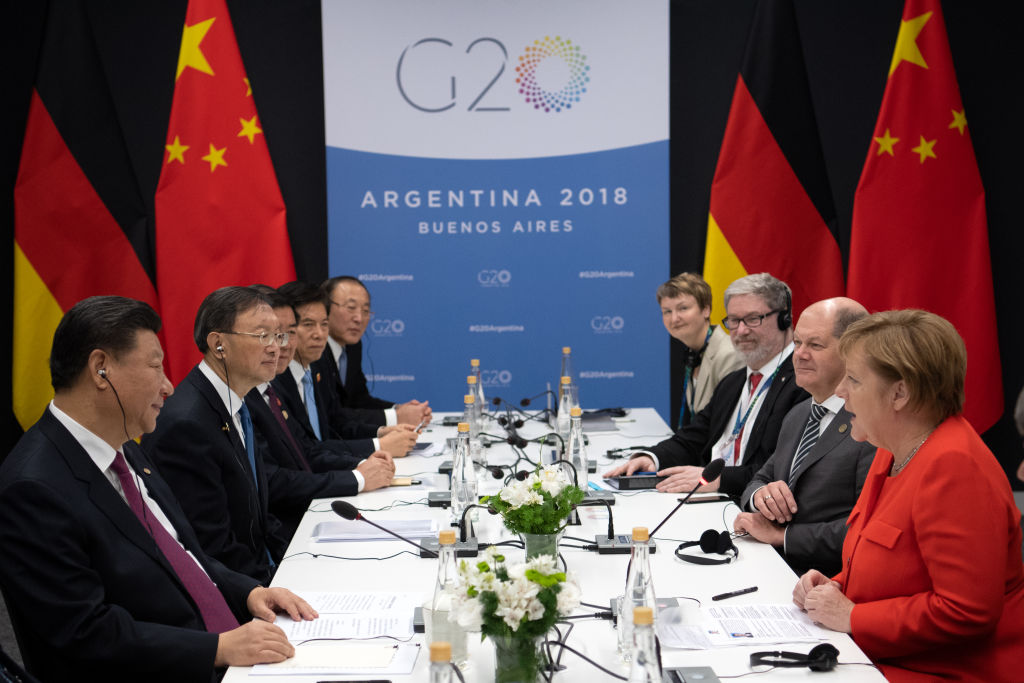 German Chancellor Angela Merkel (r, CDU) and Xi Jinping (l), President of China, meet at the G20 Summit Conference Centre for talks in Buenos Aires in 2018. (Ralf Hirschberger—picture alliance via Getty Images)
