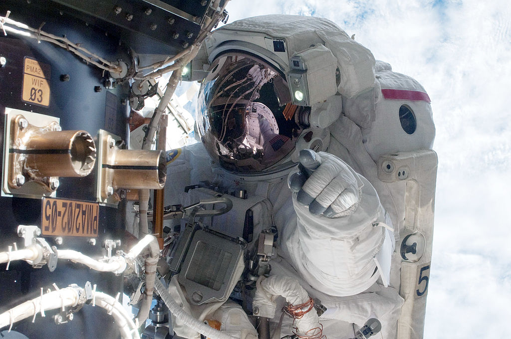 In this handout image provided by the National Aeronautics and Space Administration (NASA), NASA astronaut Mike Fossum, Expedition 28 flight engineer, waits at an International Space Station's pressurized mating adapter (PMA-2) docked to the space shuttle Atlantis, as the station's robotic system moves the failed pump module (out of frame) over to the spacewalking astronaut and the shuttle's cargo bay during a planned six-and-a-half-hour spacewalk July 12, 2011 in space. (NASA&mdash;Getty Images)