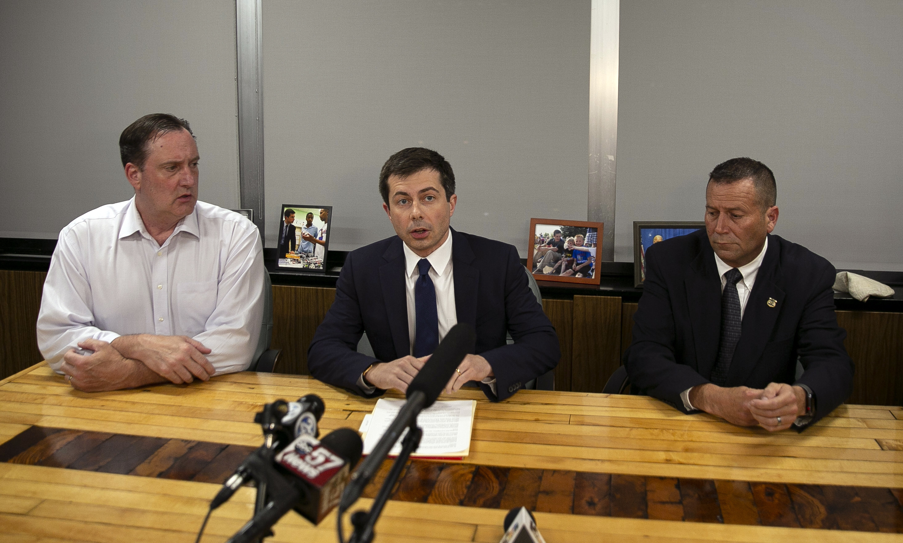 South Bend Mayor Pete Buttigieg, center, speaks during a news conference, Sunday, June 16, 2019, in South Bend, Ind., as South Bend Common Council President Tim Scott, left, and South Bend Police Chief Scott Ruszkowski, listen. Democratic presidential candidate Buttigieg changed his campaign schedule to return to South Bend for the late night news conference, after authorities say a man died after a shooting involving a police officer. (Santiago Flores—South Bend Tribune/AP)
