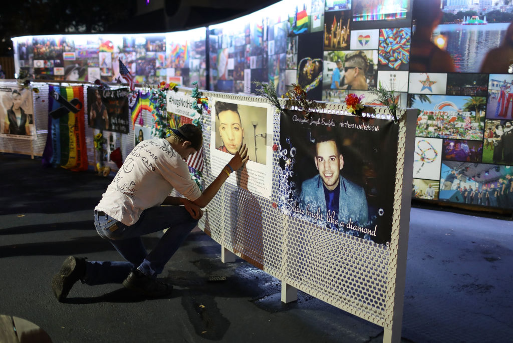 William True spends a moment in front of a picture of his friend Luis Omar Ocasio-Capo at the memorial to the 49 shooting victims setup at the Pulse nightclub on June 11, 2018 in Orlando, Florida. On June 12, 2016 a mass shooting took place at the Pulse nightclub killed 49 people and wounded 53. (Joe Raedle&mdash;Getty Images)