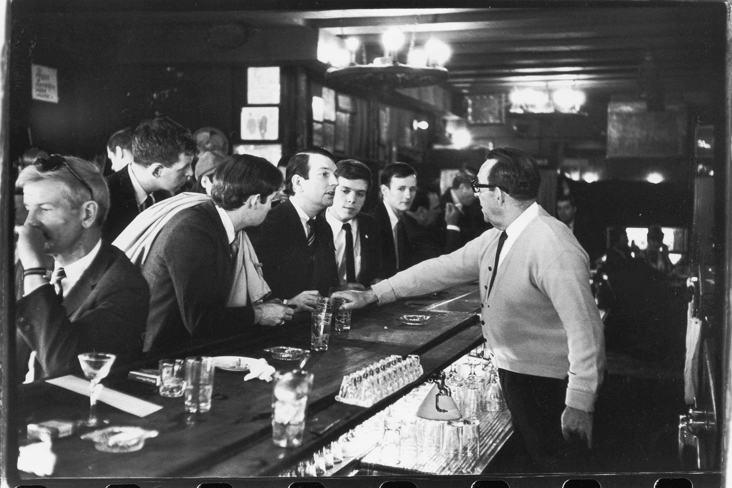 After pouring their drinks, a bartender in Julius's Bar refuses to serve (from left to right) John Timmins, Dick Leitsch, Craig Rodwell, and Randy Wicker, members of the Mattachine Society, who were protesting New York liquor laws that prevented serving gay customers, in New York, on April 21, 1966. (Fred W. McDarrah—Getty Images)