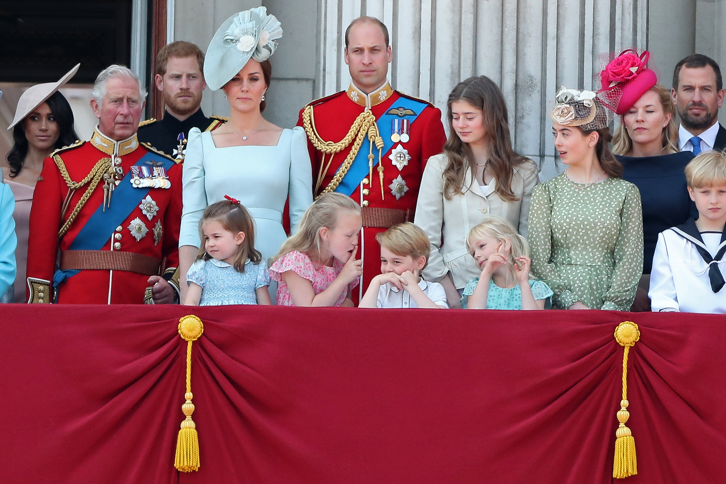 In the front row (L-R), children, Princess Charlotte of Cambridge, Savannah Phillips, Prince George of Cambridge and Isla Phillips chat on the balcony of Buckingham Palace as members of the Royal Family gather to watch a fly-past of aircraft by the Royal Air Force, in London on June 9, 2018. (DANIEL LEAL-OLIVAS—AFP/Getty Images)
