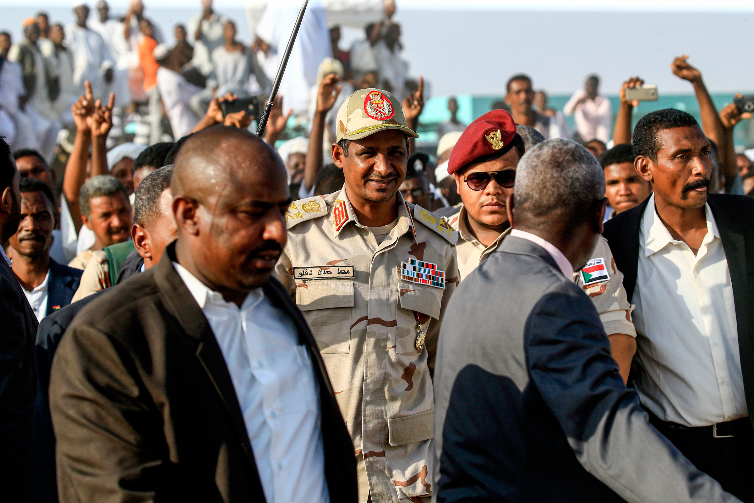 Mohamed Hamdan Dagalo, center, the deputy head of Sudan's ruling Transitional Military Council and commander of the Rapid Support Forces paramilitaries, walks in the village of Qarri, on June 15. (Ashraf Shazly—AFP/Getty Images)