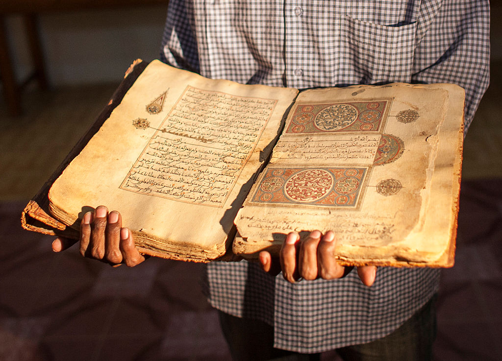 A librarian in Juma Al Majid Centre for the manuscripts conservation and restoration of Timbuktu shows one of the old manuscripts on January 19, 2010 in Timbuktu, Mali. (Andrea Borgarello—Getty Images)
