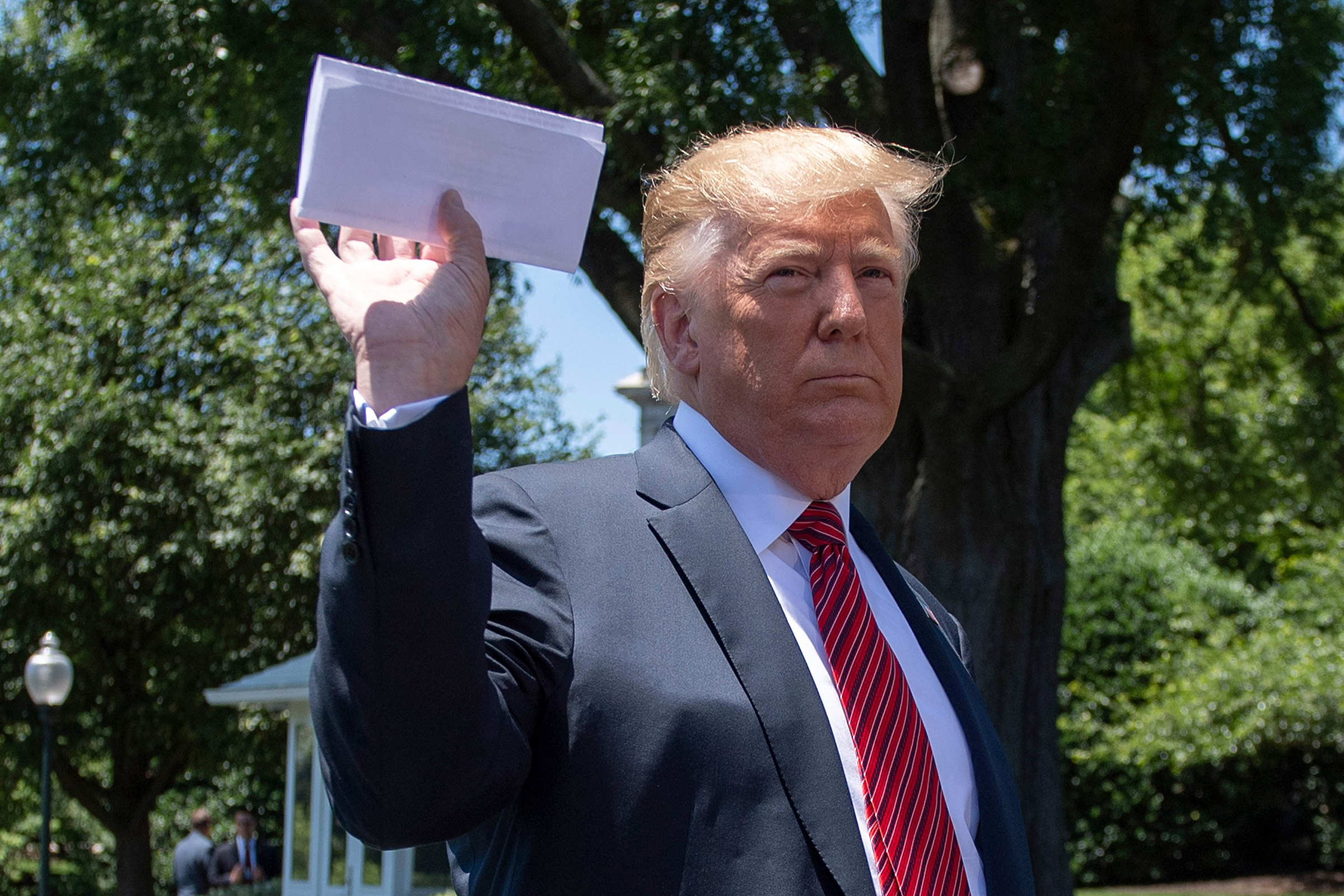 At the White House on June 11, President Trump holds what he said was a page of a new migration deal with Mexico. (Jim Watson—AFP/Getty Images)