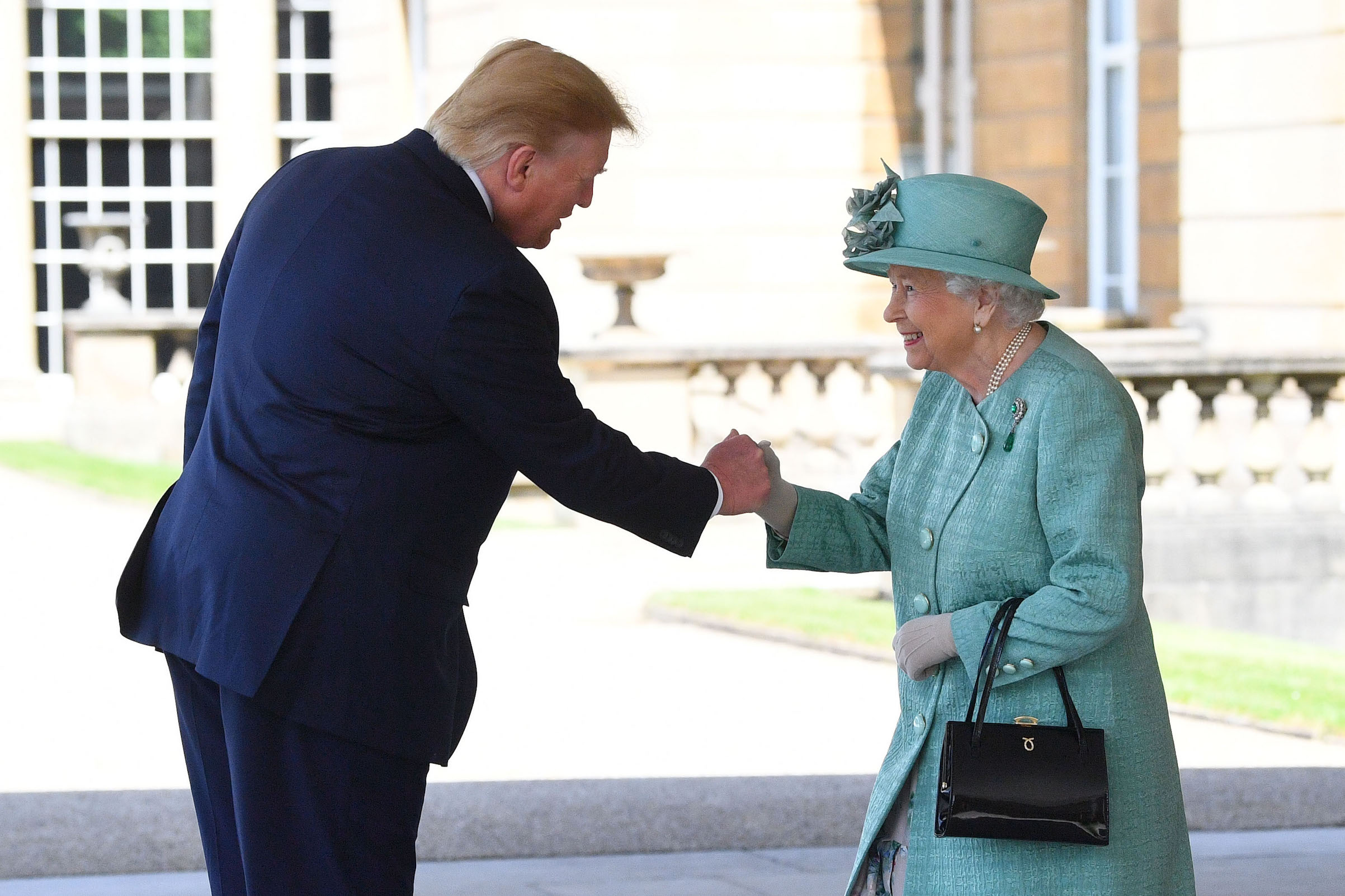 Queen Elizabeth II greets US President Donald Trump as he arrives for the Ceremonial Welcome at Buckingham Palace, London, on day one of his three day state visit to the U.K. on June 3, 2019. (Victoria Jones—Getty Images)