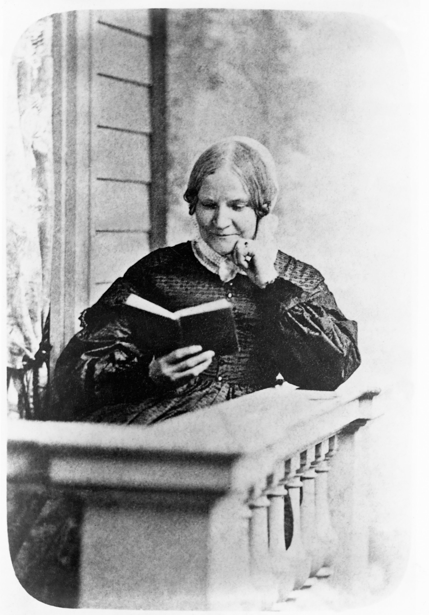 Lydia Maria Child (1802-1880) reads a book on a front porch. Child wrote and edited books promoting the suffragist and abolitionist causes. (Corbis/Getty Images)