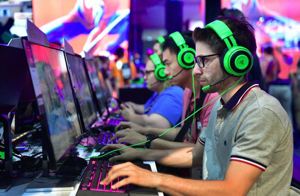Video game workers wear headsets at E3 in Los Angeles