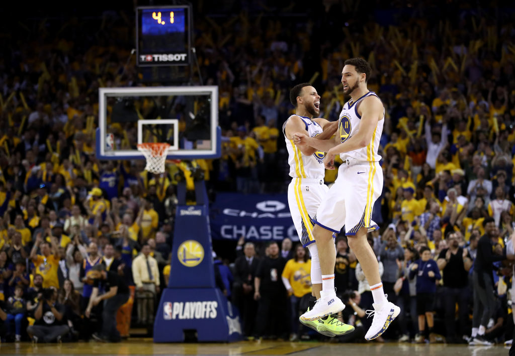 Stephen Curry #30 of the Golden State Warriors celebrates with Klay Thompson #11 after Thompson made the clinching basket with four second left of their game against the Houston Rockets in Game Five of the Western Conference Semifinals of the 2019 NBA Playoffs at ORACLE Arena on May 8, 2019 in Oakland, California. (Ezra Shaw—Getty Images)