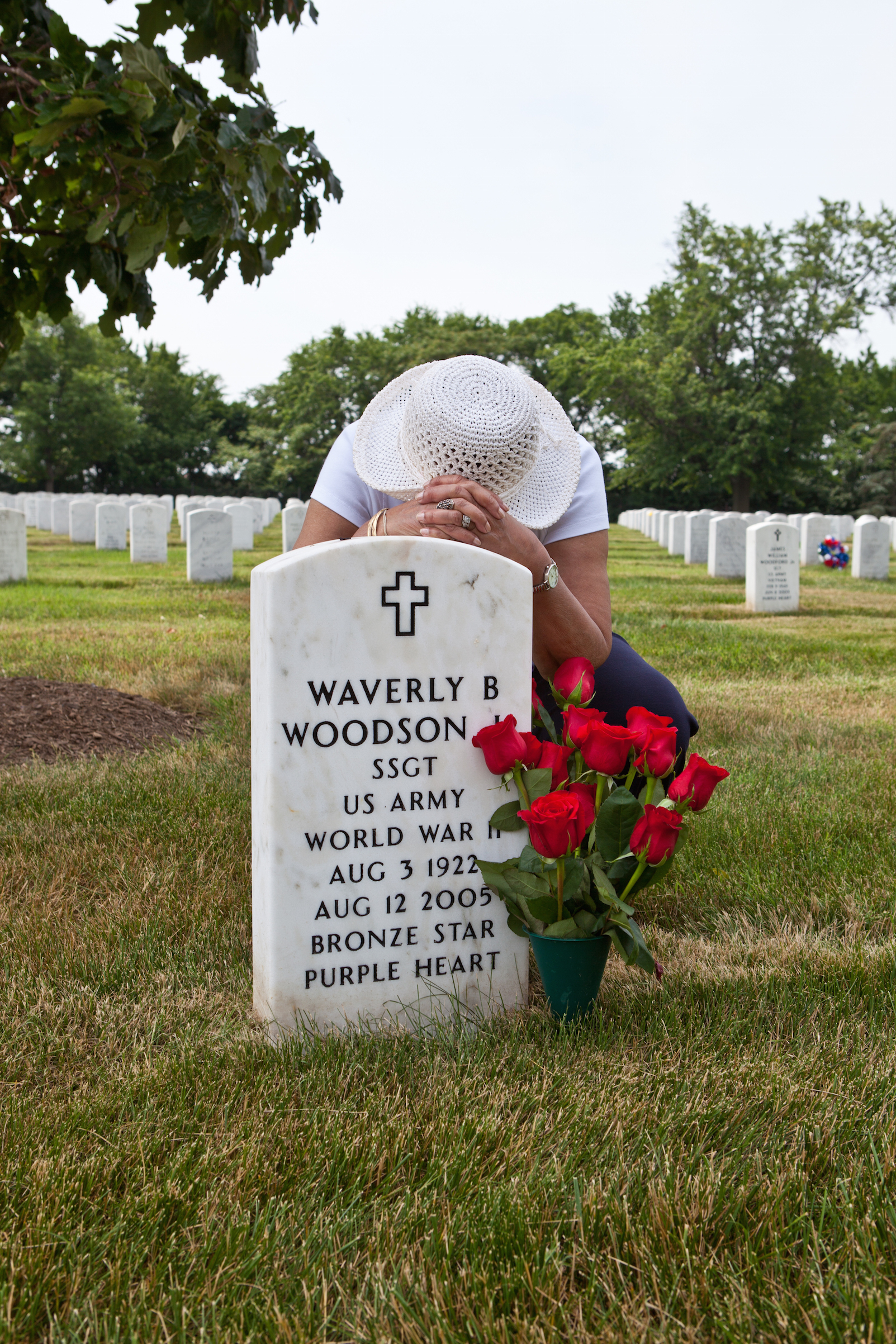 Joann Woodson visits her husband’s grave at Arlington National Cemetery with his favorite red roses. (Linda Hervieux)