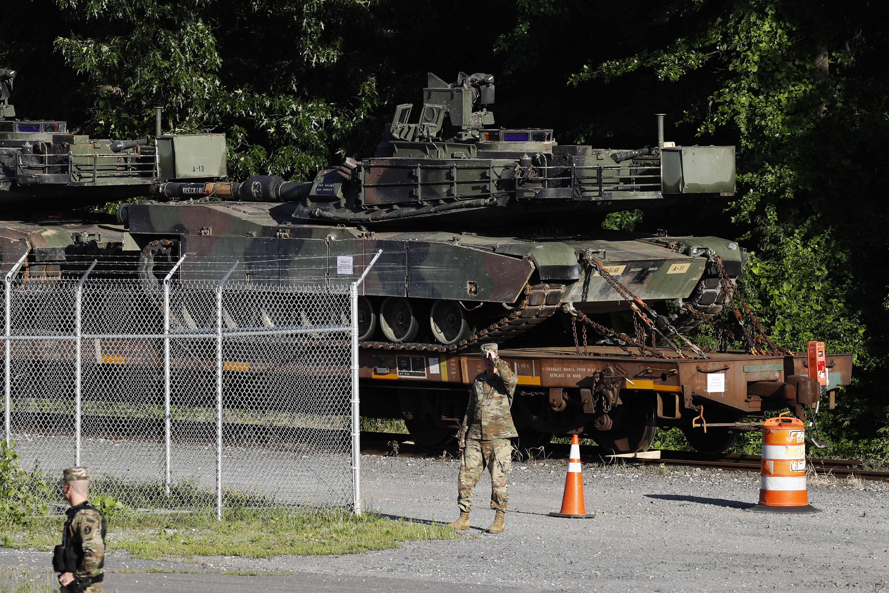 Military police walk near Abrams tanks on a flat car in a rail yard ahead of a Fourth of July celebration that President Donald Trump says will include military hardware in Washington on Monday, July 1, 2019. (Patrick Semansky—AP)