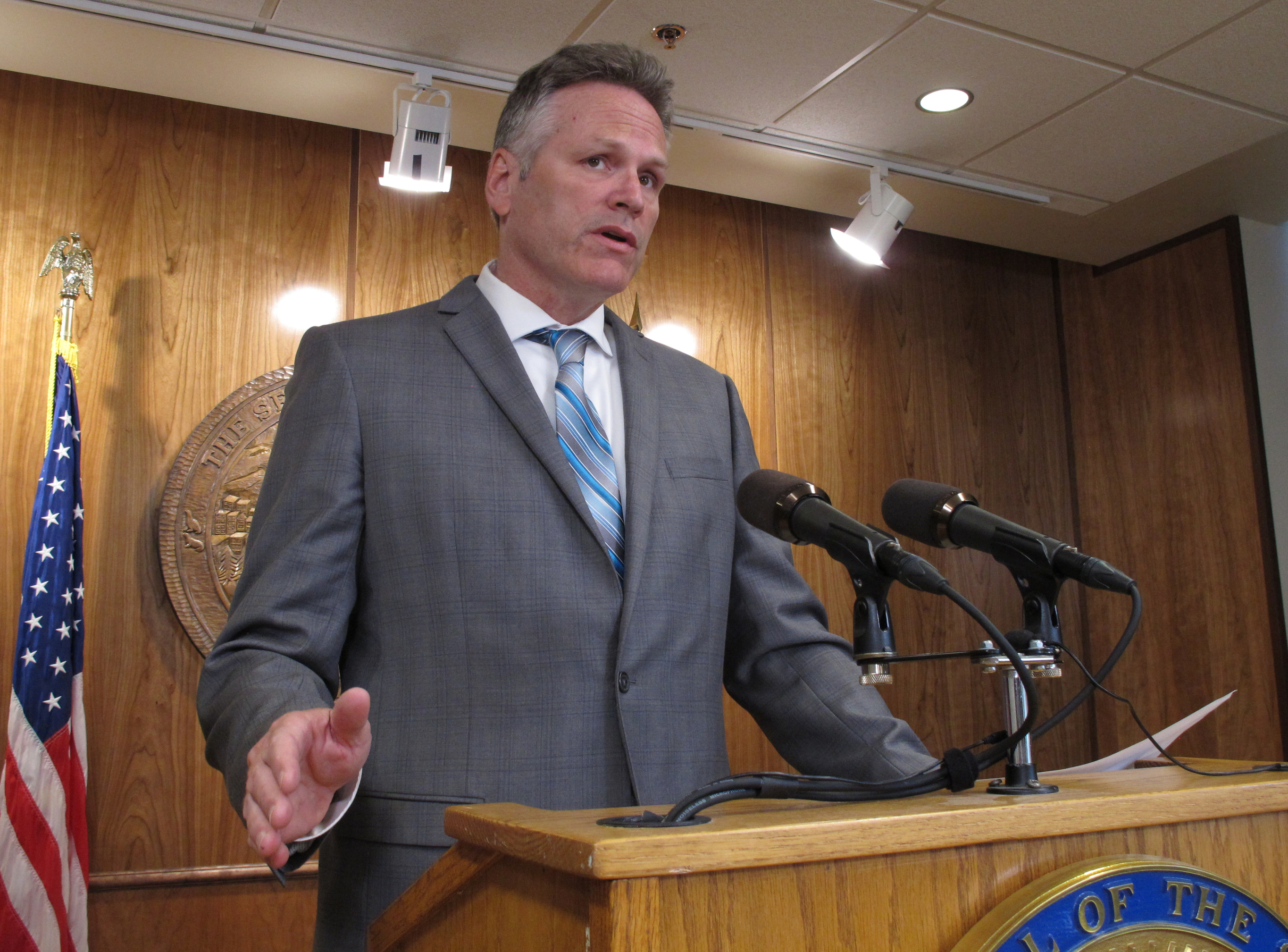 Alaska Gov. Mike Dunleavy speaks to reporters about his budget vetoes at the state Capitol in Juneau, Alaska Friday, June 28, 2019. The university system, health and social service programs and public broadcasting were among the areas affected by vetoes. The budget agreed to by the House and Senate cut state support for the university system by a fraction of what Dunleavy proposed. Lawmakers have the ability to override budget vetoes if they can muster sufficient support. (Becky Bohrer&mdash;AP)