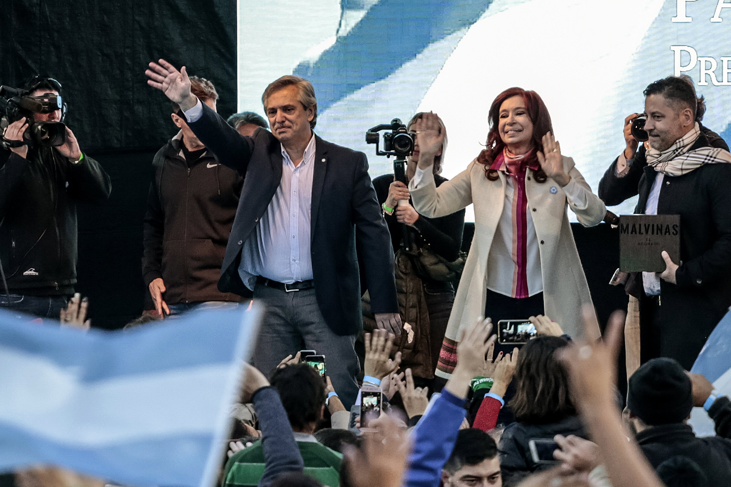 Presidential candidate Alberto Fernandez and former president of Argentina Cristina Fernandez de Kirchner wave to attendees during their first campaign event in Merlo, Argentina, on May 25. (Sarah Pabst—Bloomberg/Getty Images)