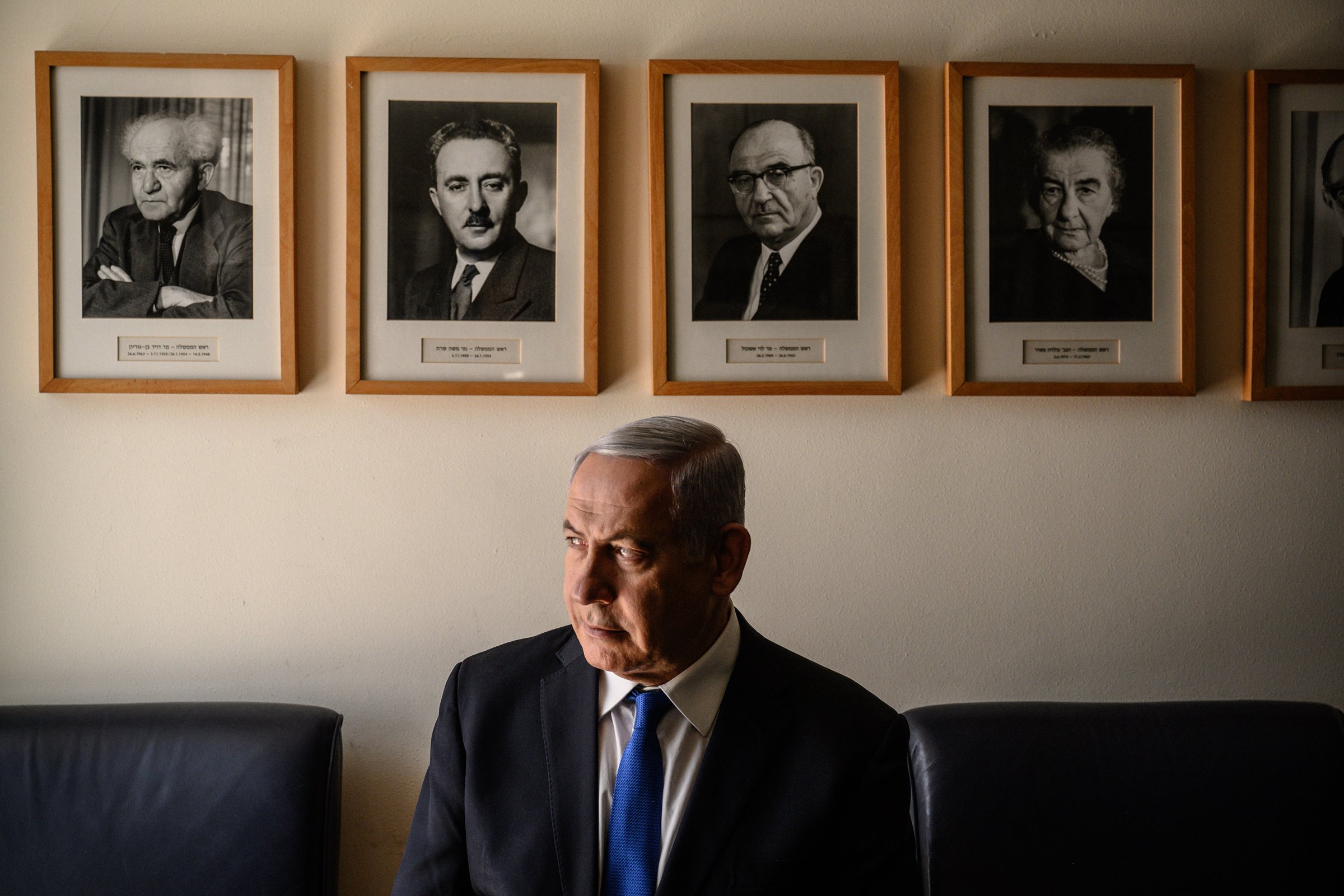 Netanyahu in his Jerusalem office, with portraits of Israel’s early Prime Ministers, starting with David Ben-Gurion, top left.