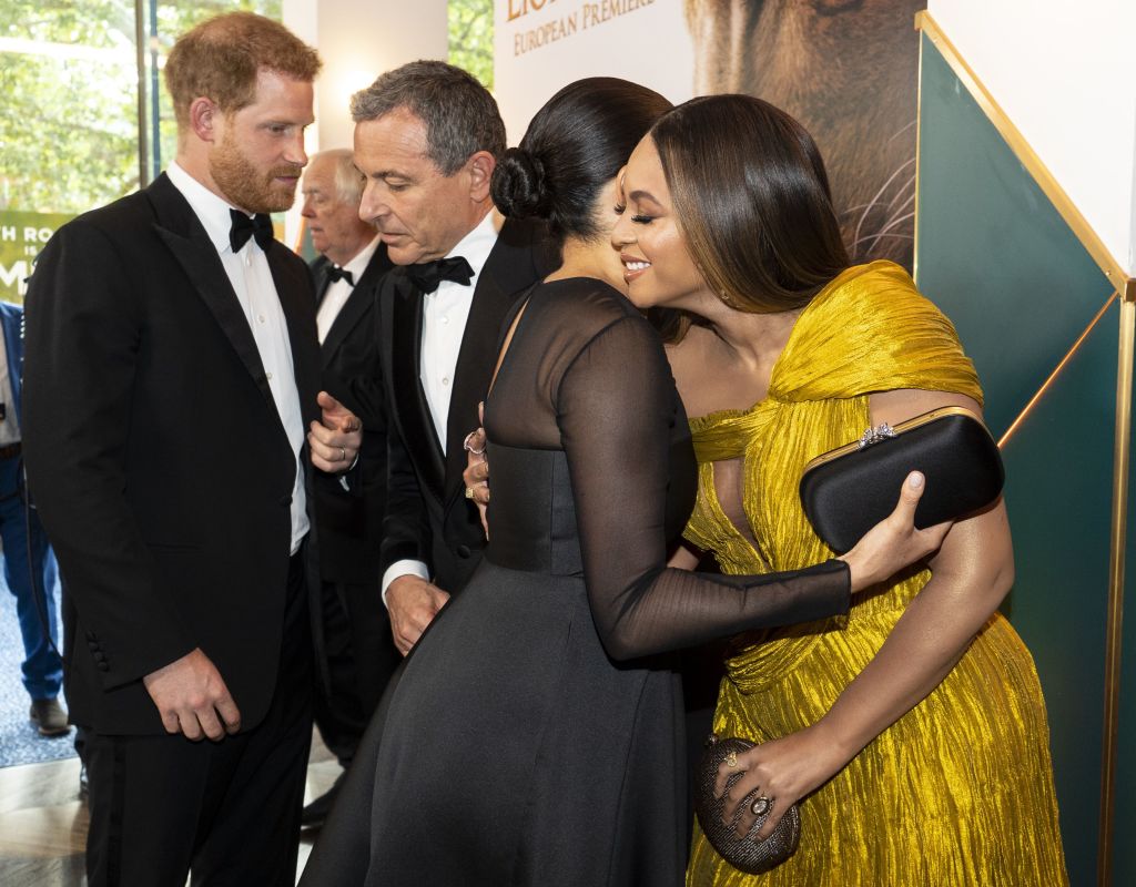 Britain's Prince Harry, Duke of Sussex (L) chats with Disney CEO Robert Iger as Britain's Meghan, Duchess of Sussex (2nd R) embraces US singer-songwriter Beyoncé (R) as they attend the European premiere of the film The Lion King in London on July 14, 2019. (Niklas Halle'n—AFP/Getty Images)