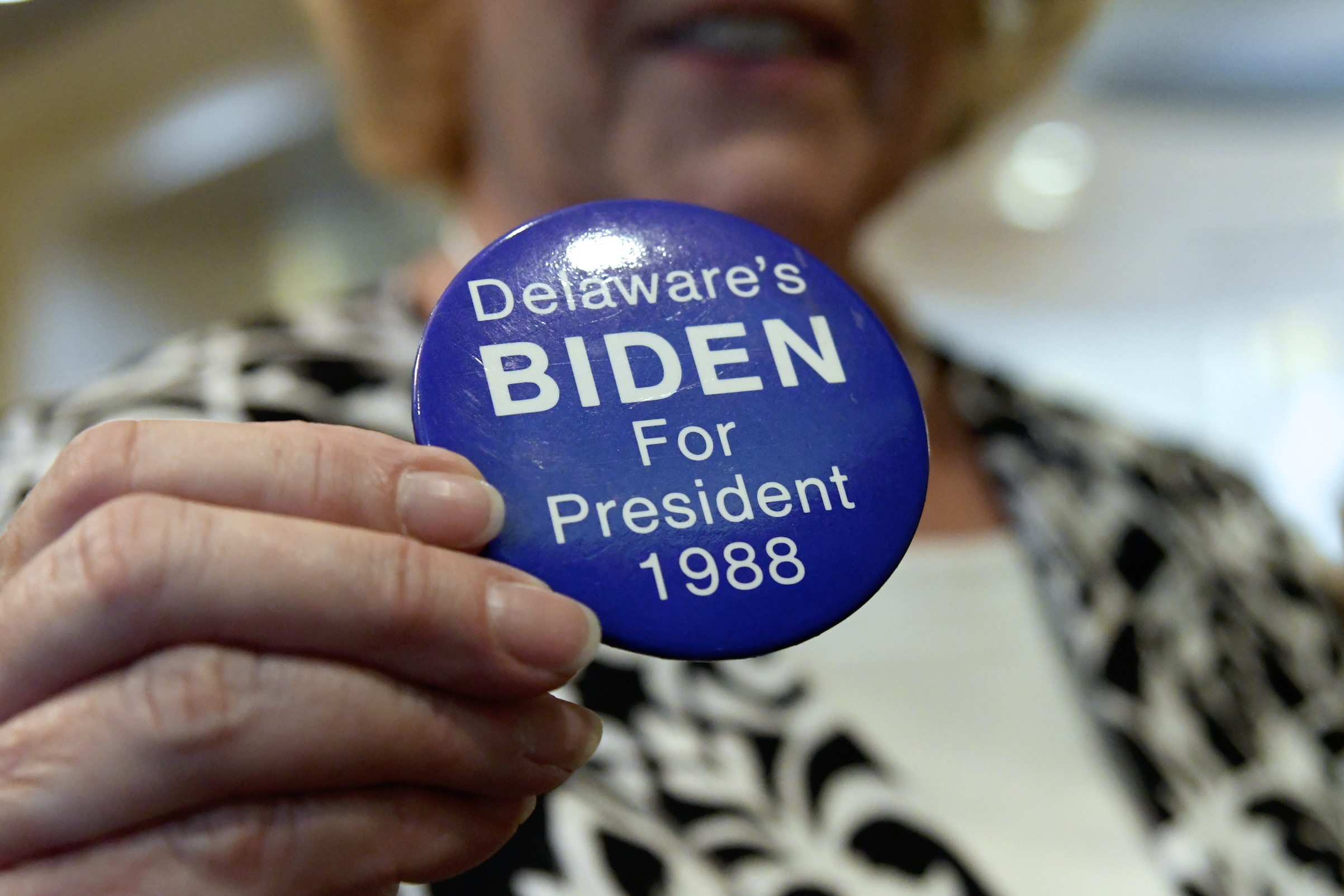 A supporter holds up a Biden for President button from 1988 in Dover, Del., on March 16, 2019. (Bastiaan Slabbers—NurPhoto via Getty Images)