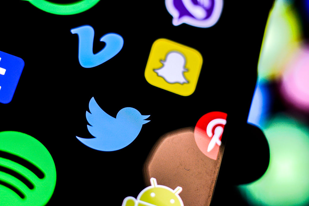 A Twitter logo is seen on an iPhone screen in this photo illustration in Warsaw, Poland on March 5, 2019. (Jaap Arriens—NurPhoto/Getty Images)