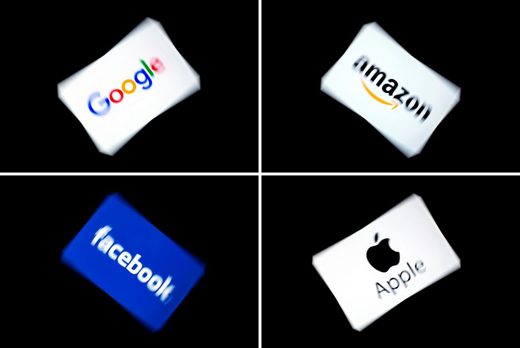 This combination of pictures shows the logos of the GAFA's, named after US  multinational technology and Internet-related services company Google, US online retail giant Amazon, US social media Facebook and US multinational technology company Apple, displayed on a tablet in Paris, on February 18, 2019. (LIONEL BONAVENTURE/AFP/Getty Images)