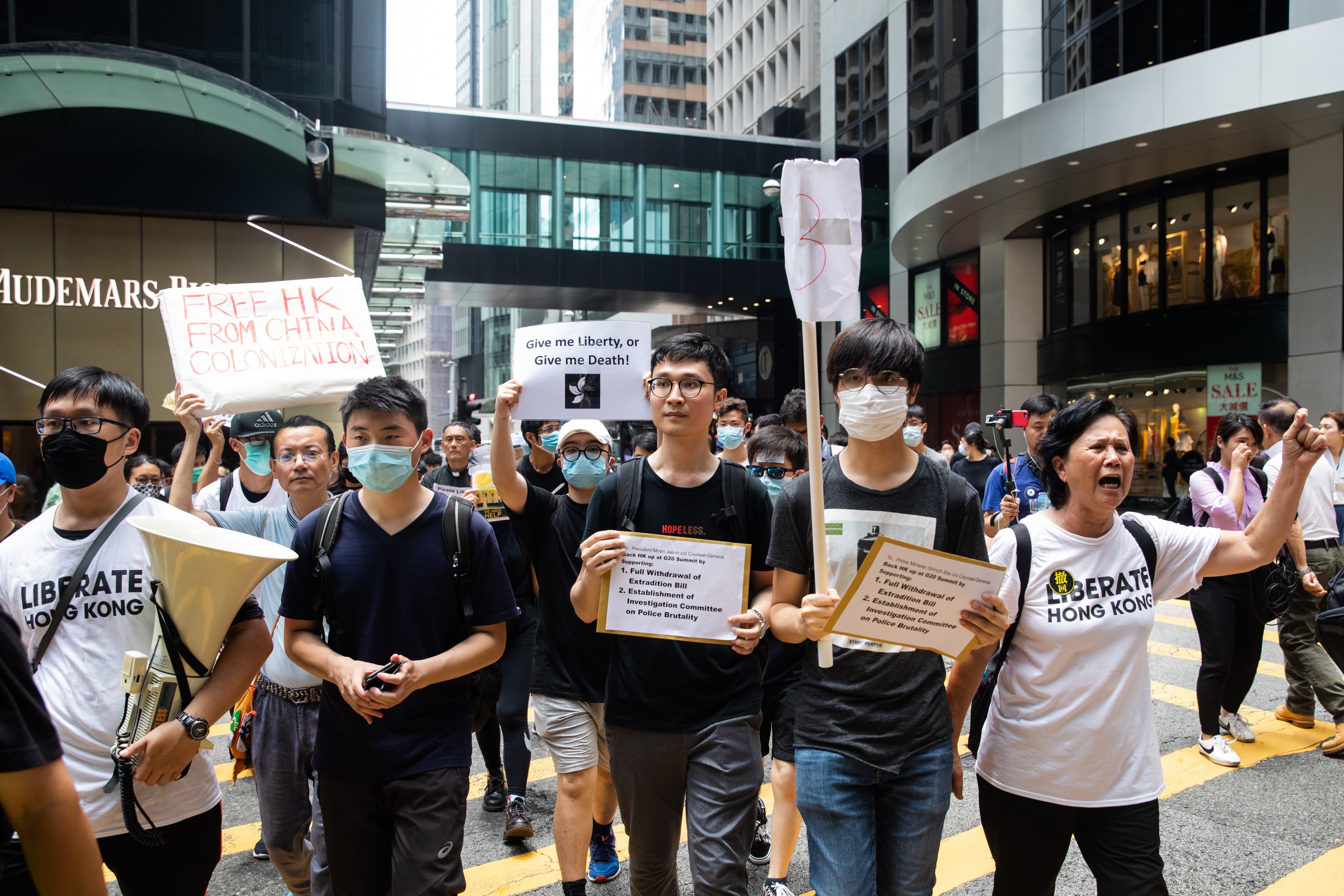 Ventus Lau (C) leads a march to deliver letters to local G-20 consulates urging global intervention against a proposed extradition bill in Hong Kong, China, on Wednesday, June 26, 2019. (Kyle Lam/Bloomberg via Getty Images)
