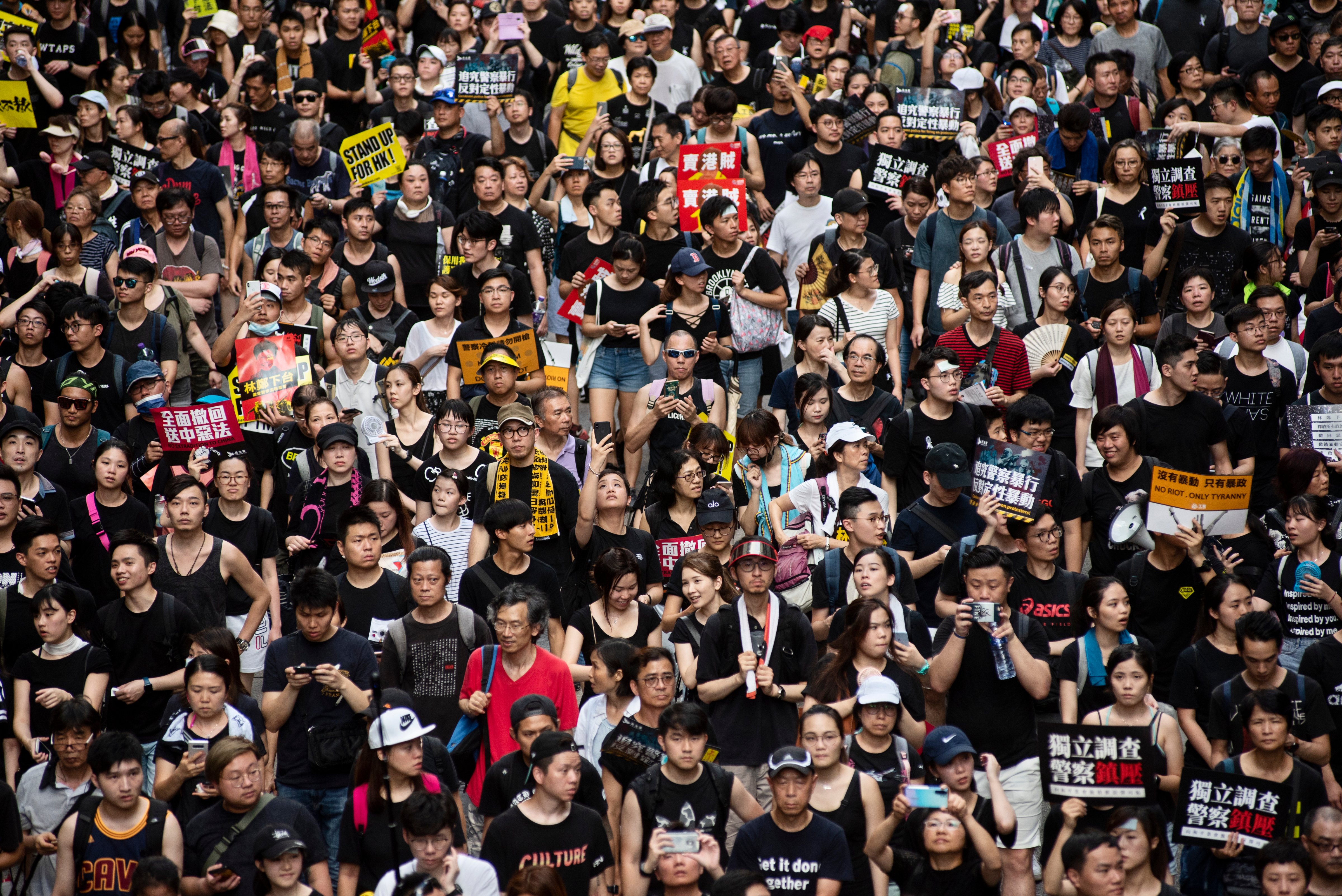 Demonstrators in Hong Kong hold anti-government placards and chant slogans during a march on July 1, 2019. (Miguel Candela/SOPA Images/LightRocket via Getty Images)
