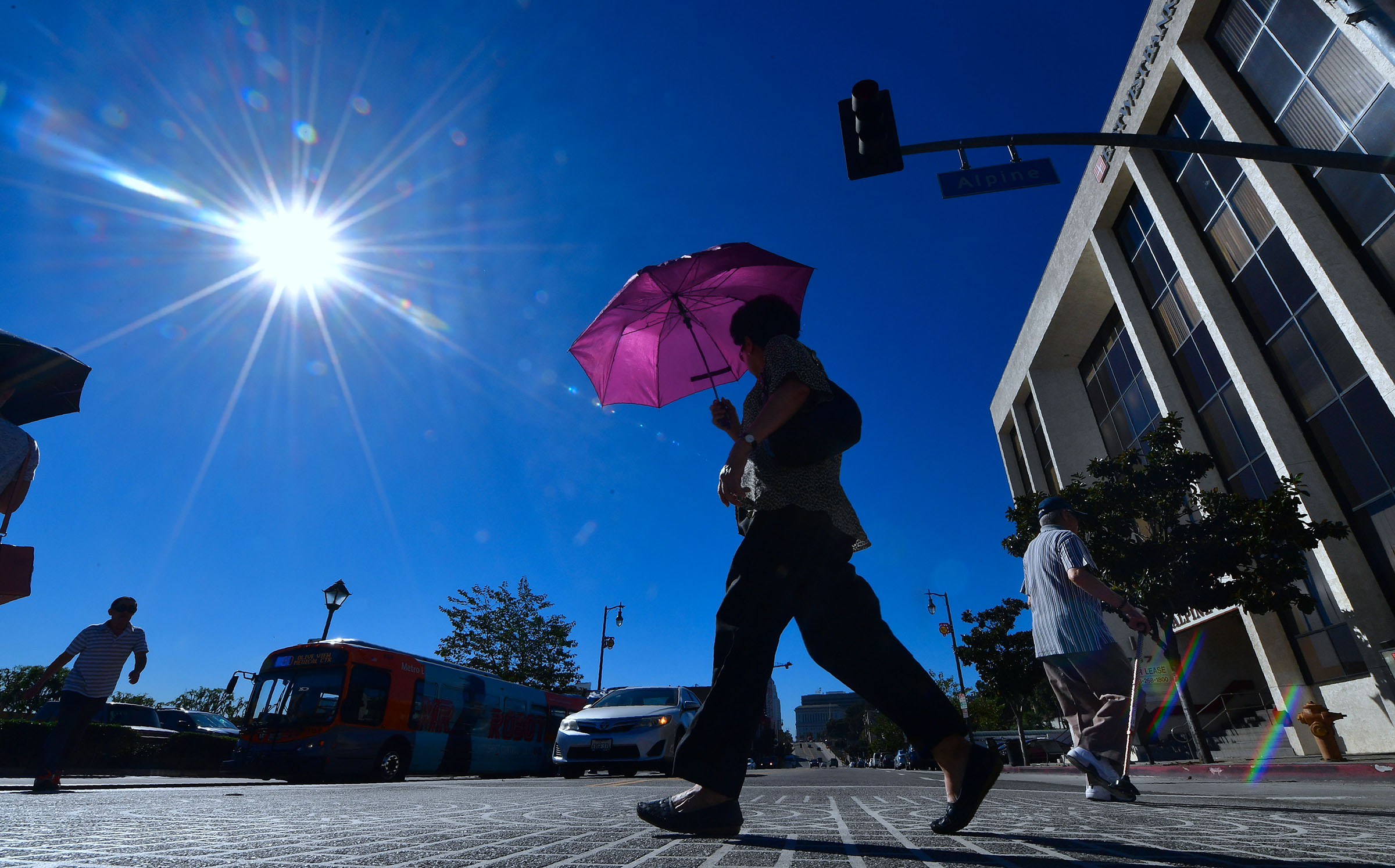 A pedestrian uses an umbrella on a hot sunny morning in Los Angeles on October 24, 2017 amid a late season heatwave hitting southern California. (Frederic J. Brown—AFP/Getty Images)