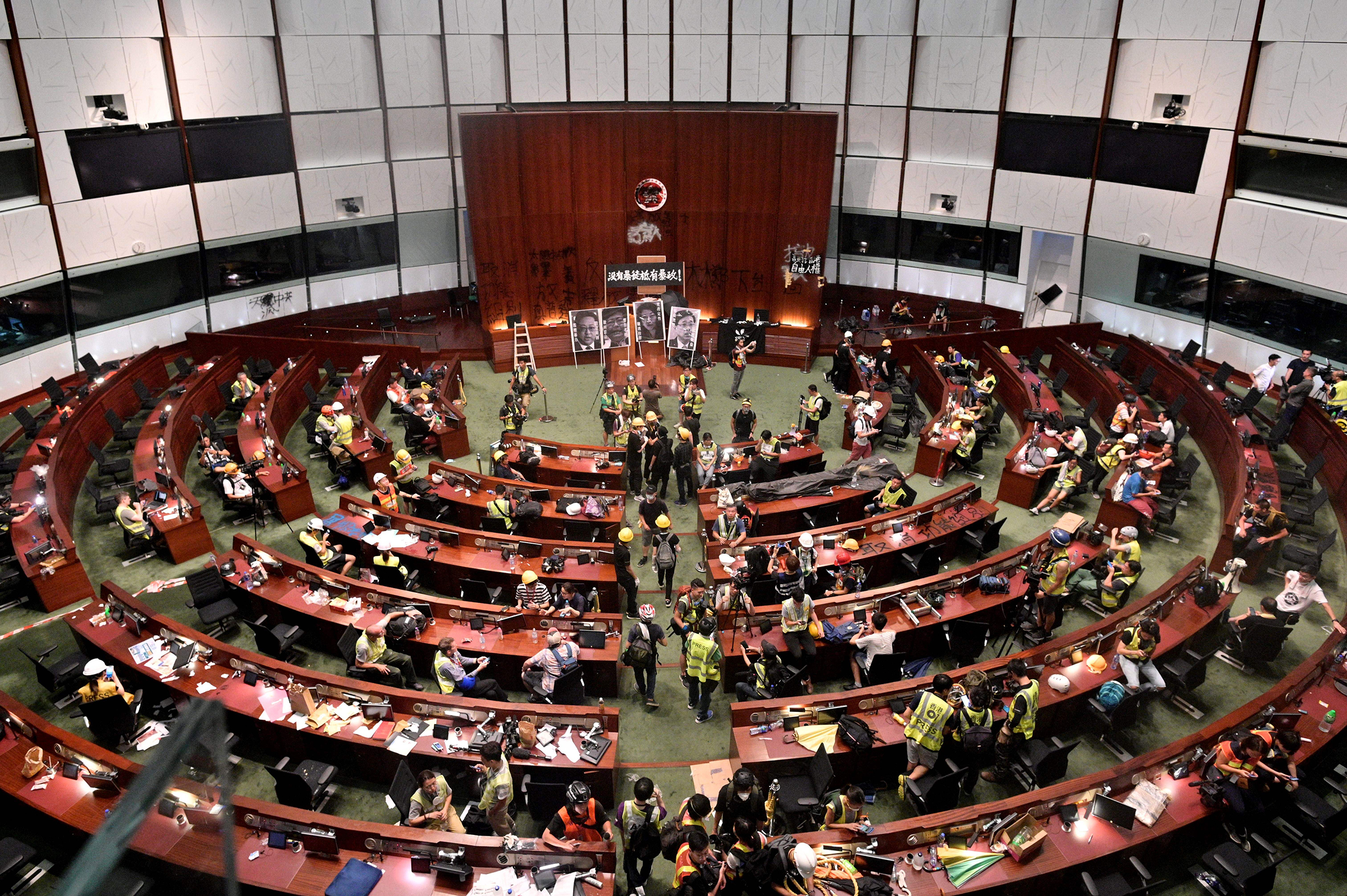 Protesters and members of the media are seen in the chambers after demonstrators broke into the government headquarters in Hong Kong on July 1, 2019. (Anthony Wallace—AFP/Getty Images)