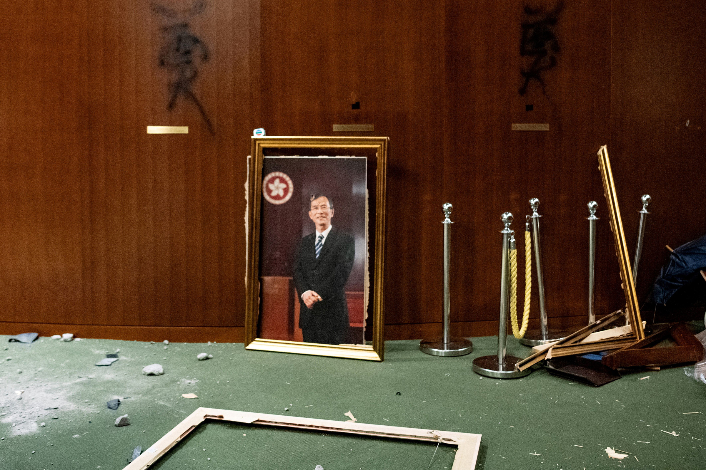 The portrait of a former chairman of the Legislative Council, Jasper Tsang, is destroyed after protesters broke into the chamber of the Legislative Council in Hong Kong on July 1, 2019. (Philip Fong—AFP/Getty Images)