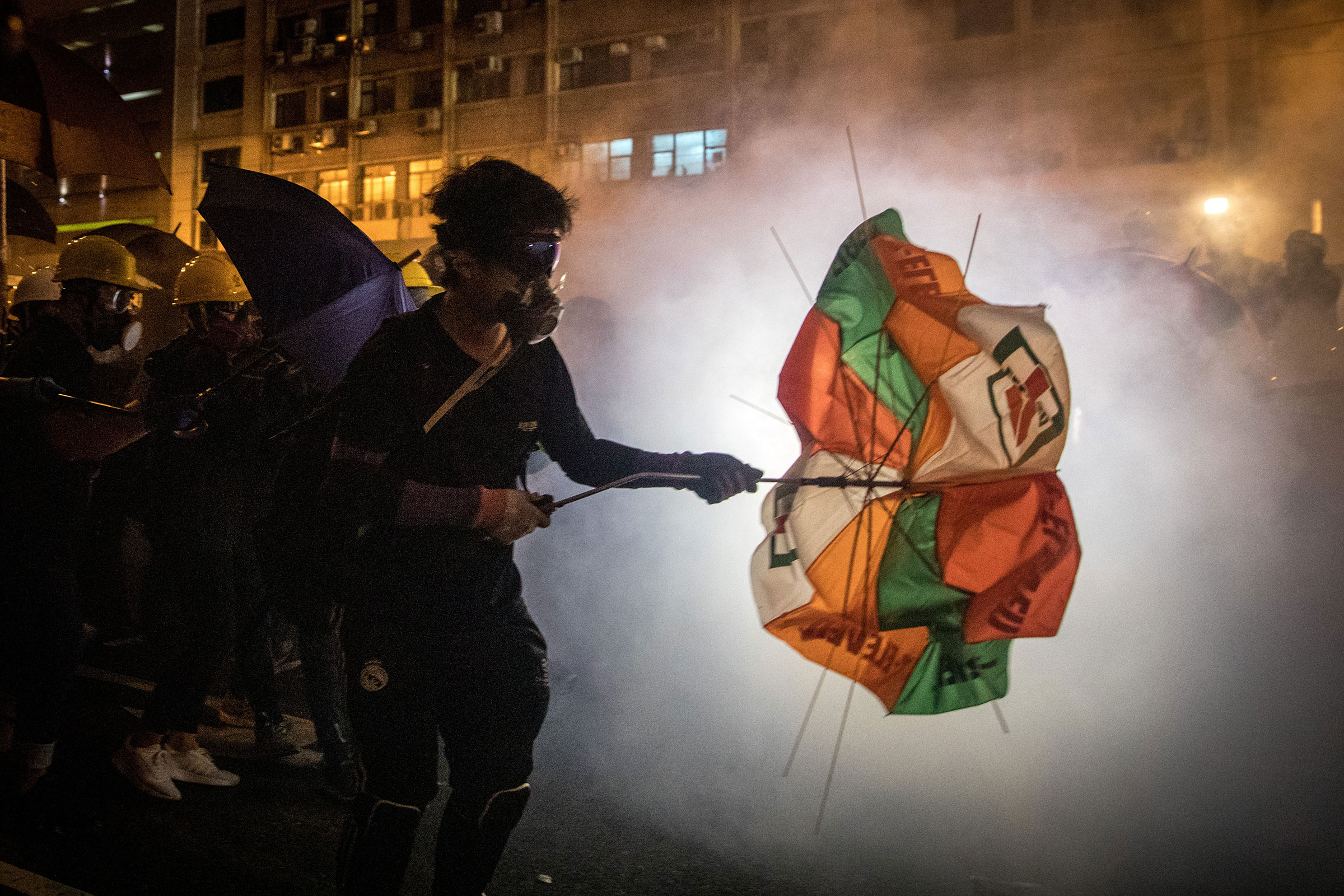 Protesters clash with police amid tear gas after taking part in an anti-extradition bill march on July 21 in Hong Kong. (Chris McGrath—Getty Images)
