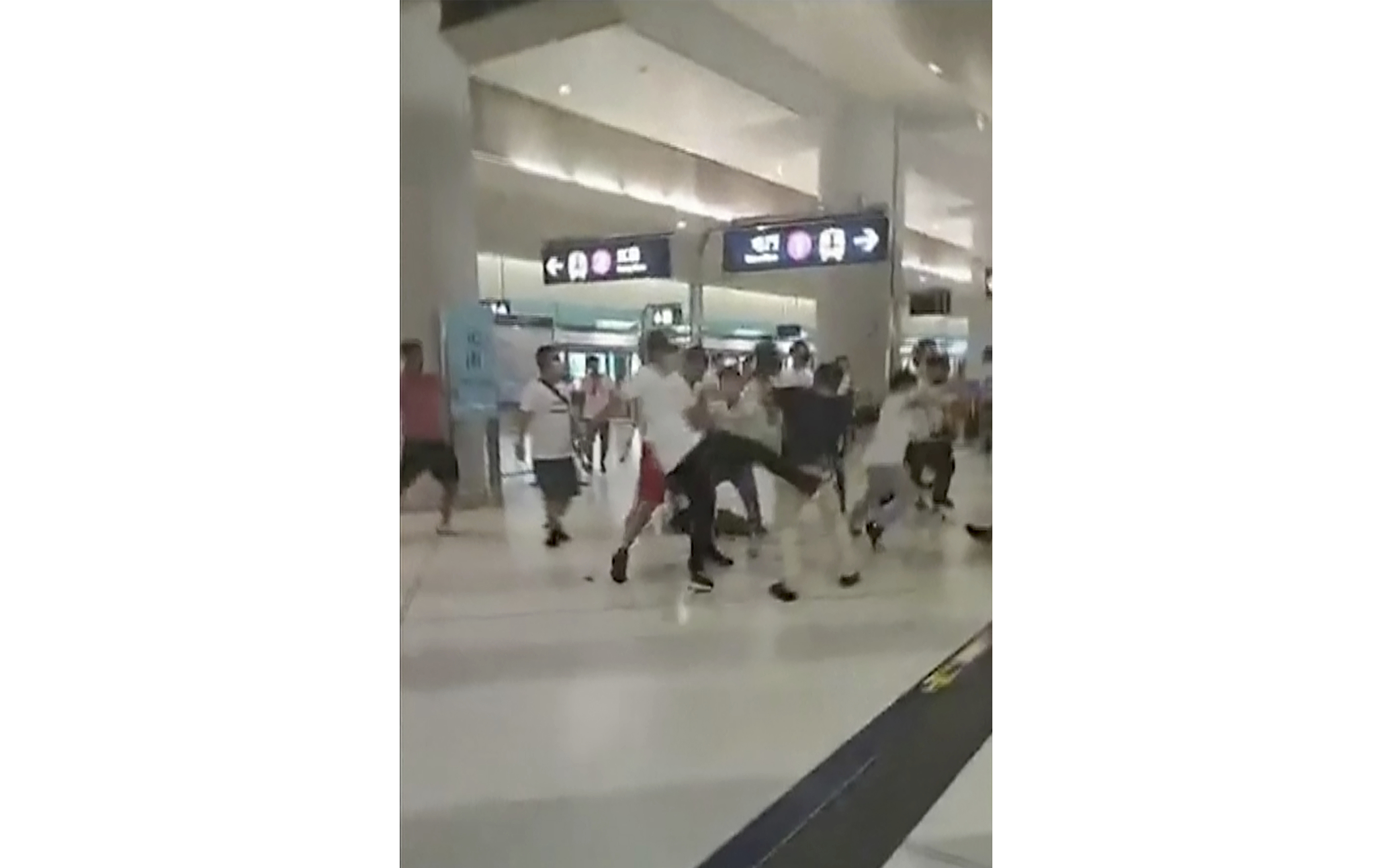 This image taken from a video shows confrontation between masked assailants and protesters at Yuen Long MTR train station in Hong Kong on July 21, 2019. (Lam Cheuk-ting—AP)