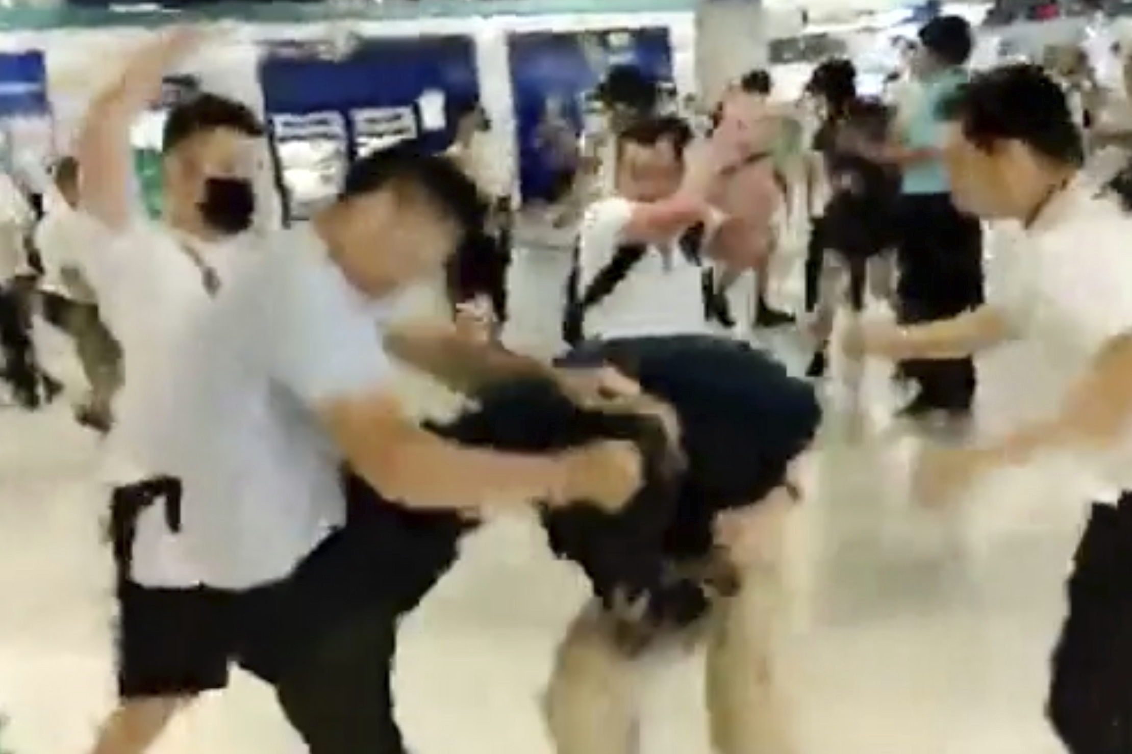 In this image taken from a video footage run by The Stand News via AP Video, white shirted men attacked a man dressed in black shirt at a subway station in Hong Kong on July 21, 2019. (Anonymous—AP)