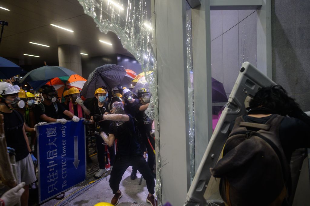 Protesters smash the glass doors and windows of the government headquarters in Hong Kong on July 1, 2019, the 22nd anniversary of the city's handover from Britain to China. (ANTHONY WALLACE—AFP/Getty Images)