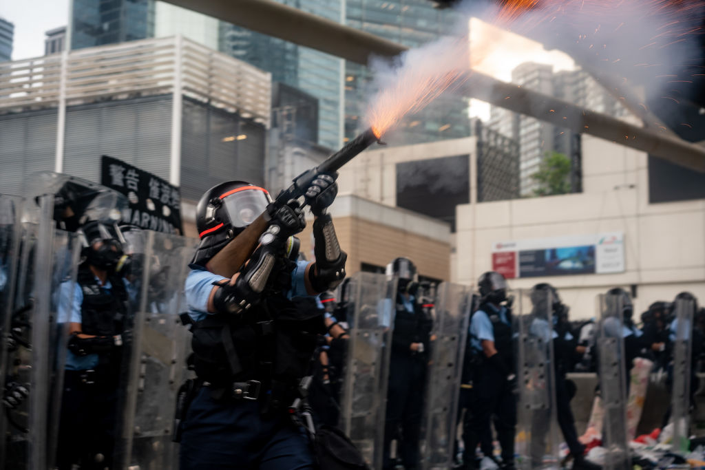 A police officer fires teargas during a protest on June 12, 2019 in Hong Kong. (Anthony Kwan—Getty Images)