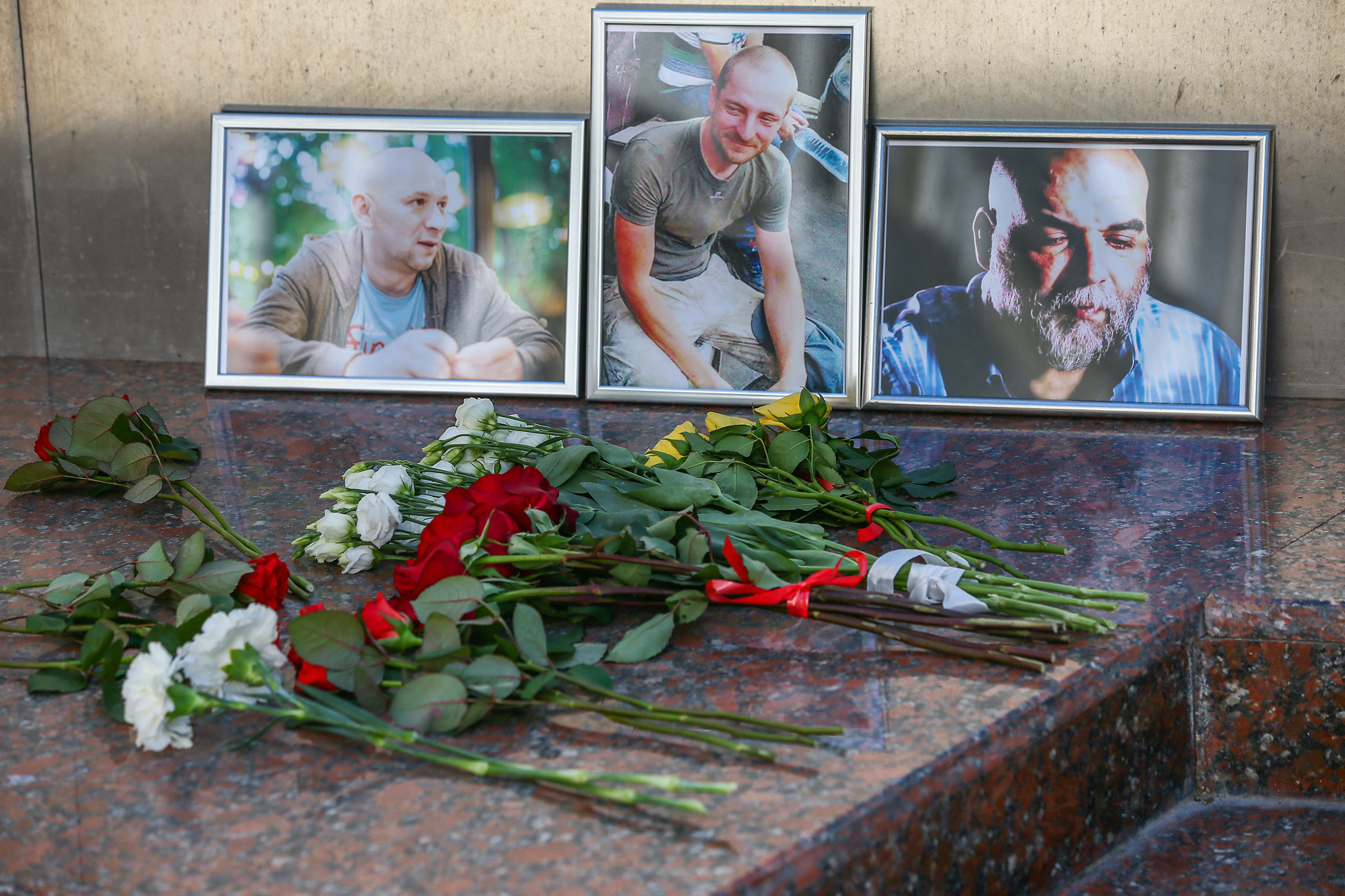 A tribute to the three Russian journalists killed in the Central African Republic (CAR), journalist Orkhan Dzhemal, cameraman Kirill Radchenko, and producer Alexander Rastorguyev, is seen at the Central House of Journalists in Moscow on August 1, 2018. (Alexander Shcherbak—TASS/Getty Images)