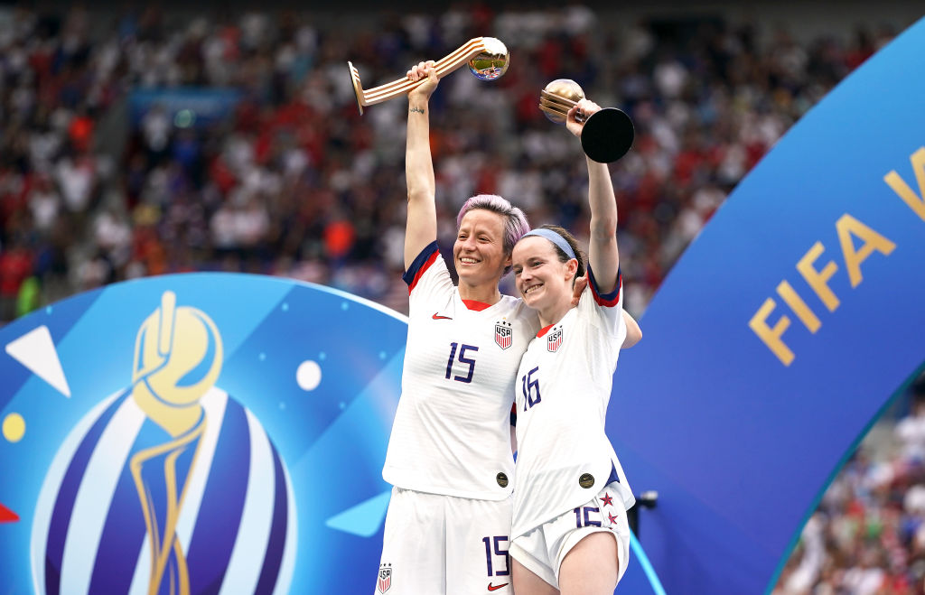 USA's Megan Rapinoe (left) and Rose Lavelle celebrate with the FIFA Women's World Cup Trophy after the final whistle USA v. Netherlands in Lyon, France, on July 7, 2019. (John Walton—EMPICS/PA Images/Getty Image)