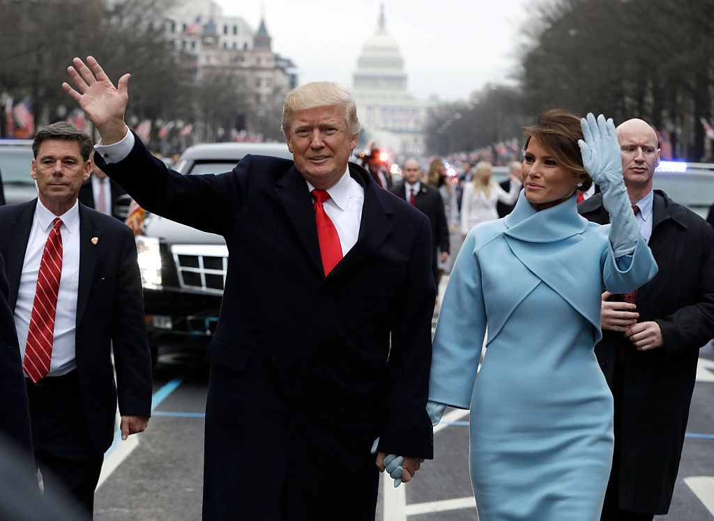 U.S. President Donald Trump waves to supporters along the parade route with first lady Melania Trump and son Barron Trump after being sworn in at the 58th Presidential Inauguration January 20, 2017 in Washington, D.C. (Pool—Getty Images)