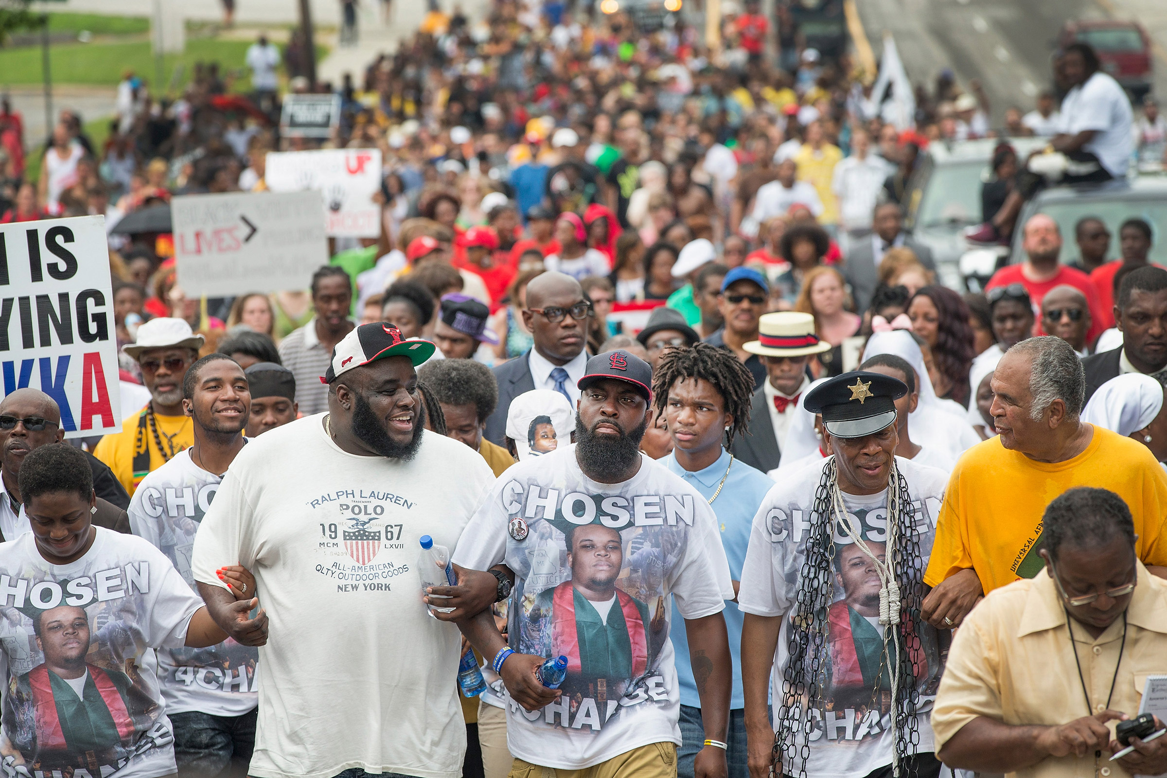 Michael Brown Sr. (center) leads a march from the location where his son Michael Brown Jr. was shot and killed following a memorial service marking the anniversary of his death in Ferguson, Mo. on Aug. 9, 2015. (Scott Olson—Getty Images)