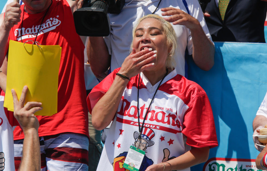 Miki Sudo eats as she attends the women's hot dog eating contest on July 4, 2019 in New York City. Nathan's held its first hot dog eating contest in Coney Island on July 4, 1916. (Kena Betancur—Getty Images)