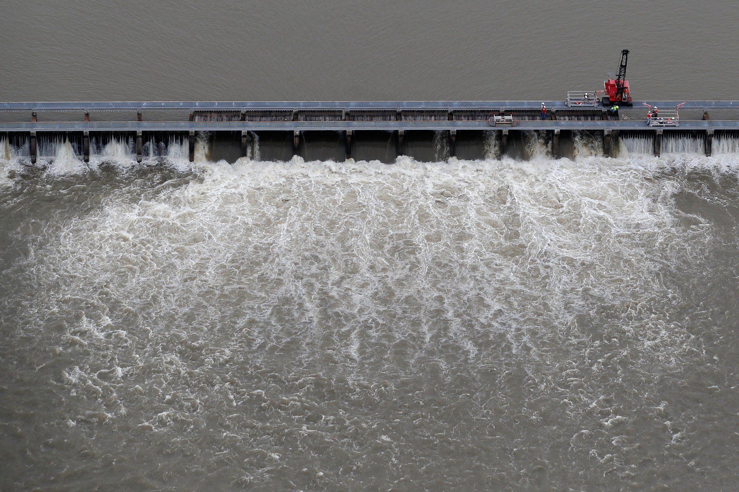 Workers open bays of the Bonnet Carre Spillway, to divert rising water from the Mississippi River to Lake Pontchartrain, upriver from New Orleans, in Norco, La., on May 10, 2019. (Gerald Herbert—AP)
