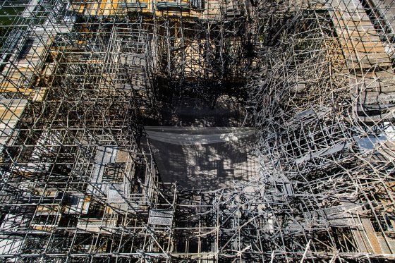 Burnt scaffolding, as seen from above in late July, will be removed.