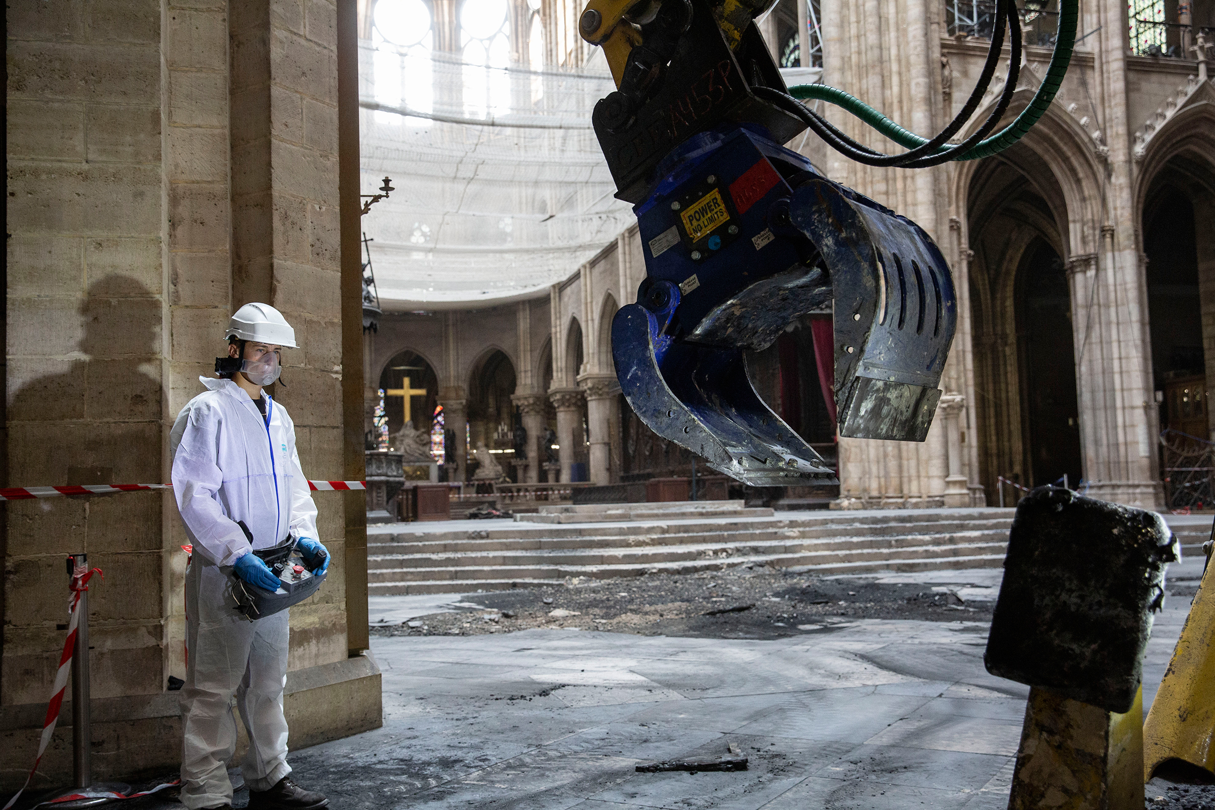 A technician clears rubble inside the cathedral on July 11. (Patrick Zachmann—Magnum Photos for TIME)