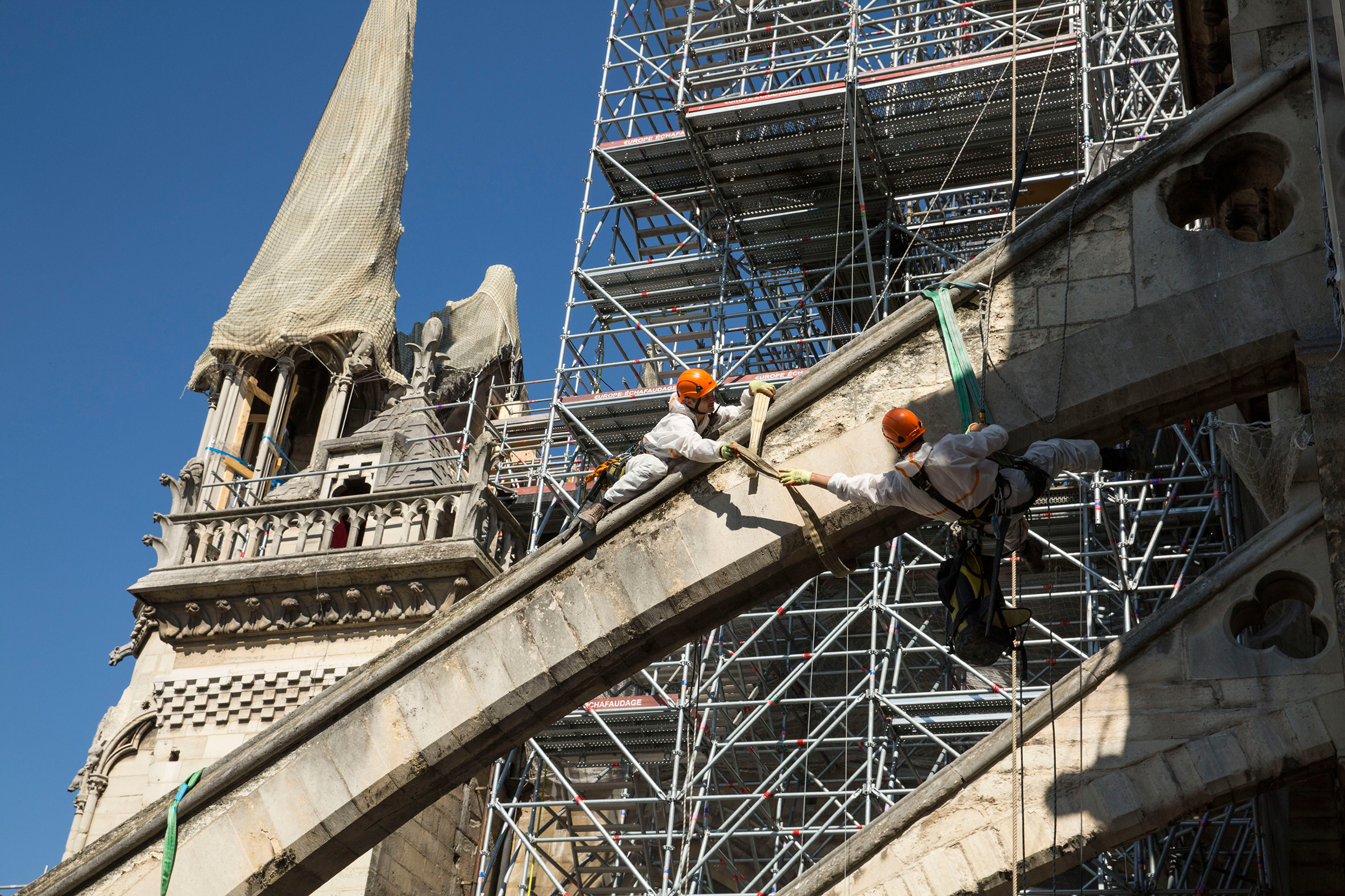 Workers prepare the flying buttresses, where wooden arches will be installed to support the structure. (Patrick Zachmann—Magnum Photos for TIME)