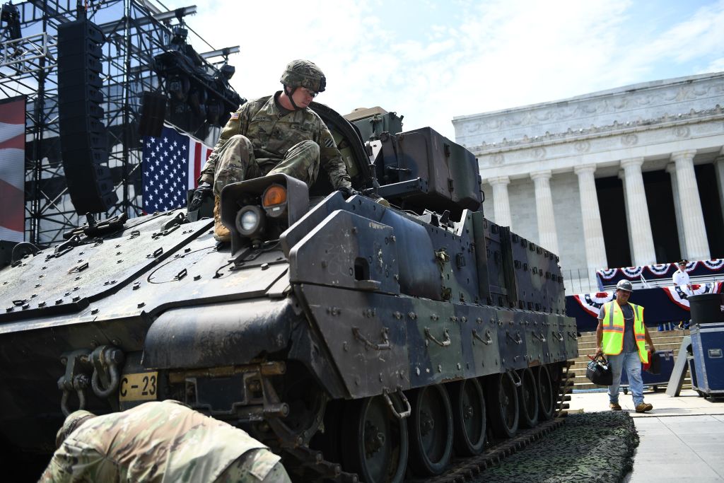 Members of the US military are seen next to a Bradley Fighting Vehicle as preparations are made for the "Salute to America" Fourth of July event with US President Donald Trump at the Lincoln Memorial on the National Mall in Washington, DC, July 3. (BRENDAN SMIALOWSKI&mdash;AFP/Getty Images)