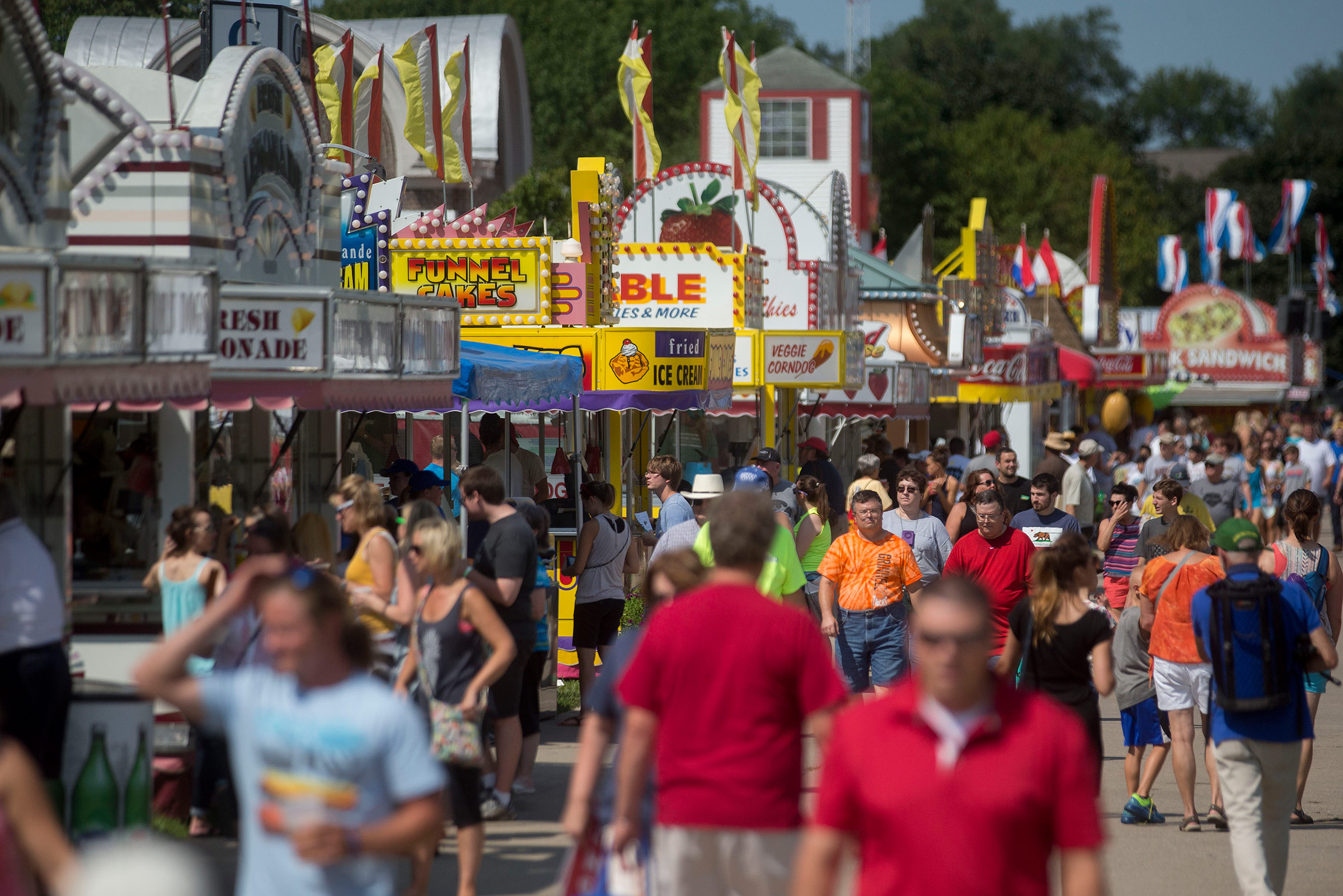 Attendees walk past food stands at the Iowa State Fair in Des Moines, Iowa, U.S. in August 2015. (Andrew Harrer—Bloomberg/Getty Images)