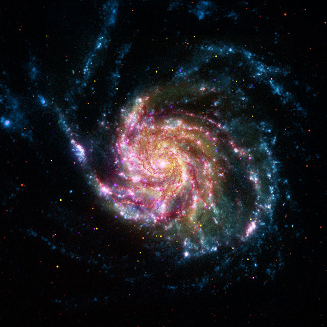 This image of Messier 101, also known as the Pinwheel Galaxy, combines data in the infrared, visible, ultraviolet and X-rays from Spitzer and three other NASA space telescopes. (NASA/JPL-Caltech/STScI/CXC)