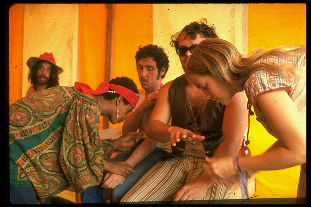 Two unidentified women giving medical care to unidentified men, during the Woodstock Music &amp; Art Fair. (John Dominis—The LIFE Picture Collection/Getty Images)