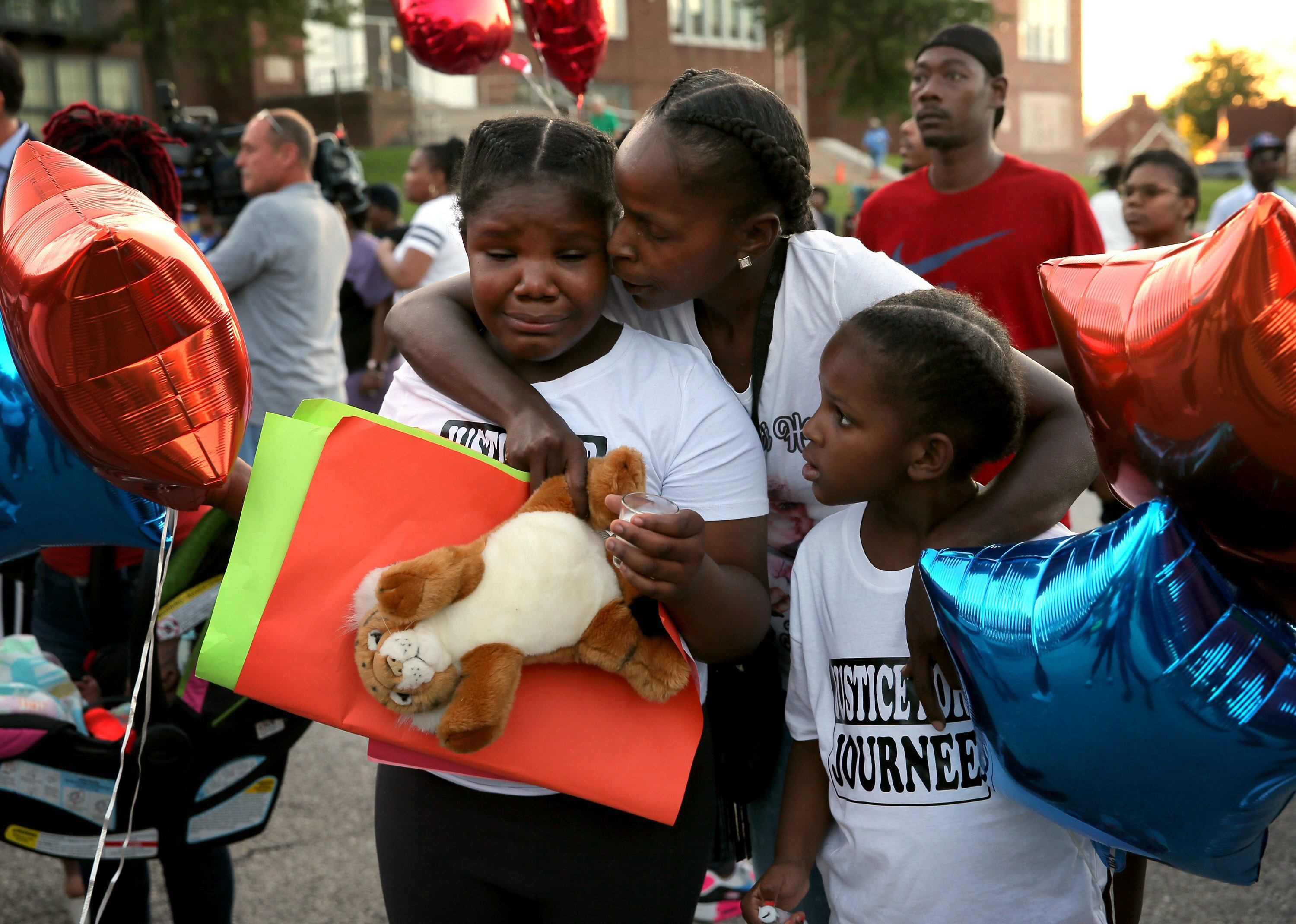 Shardae Edmondson, 11, is consoled by her mother Sharonda Edmondson and sister Zha'lea Thompson, 7, during a vigil for murdered children in St. Louis held at Herzog Elementary School in St. Louis, on Wednesday, Aug. 28, 2019. Shardae and Zha'lea are sisters of 8-year-old Jurnee Thompson who was killed by a stray bullet last Friday night. (David Carson/St. Louis Post-Dispatch via AP) (David Carson&mdash;AP)