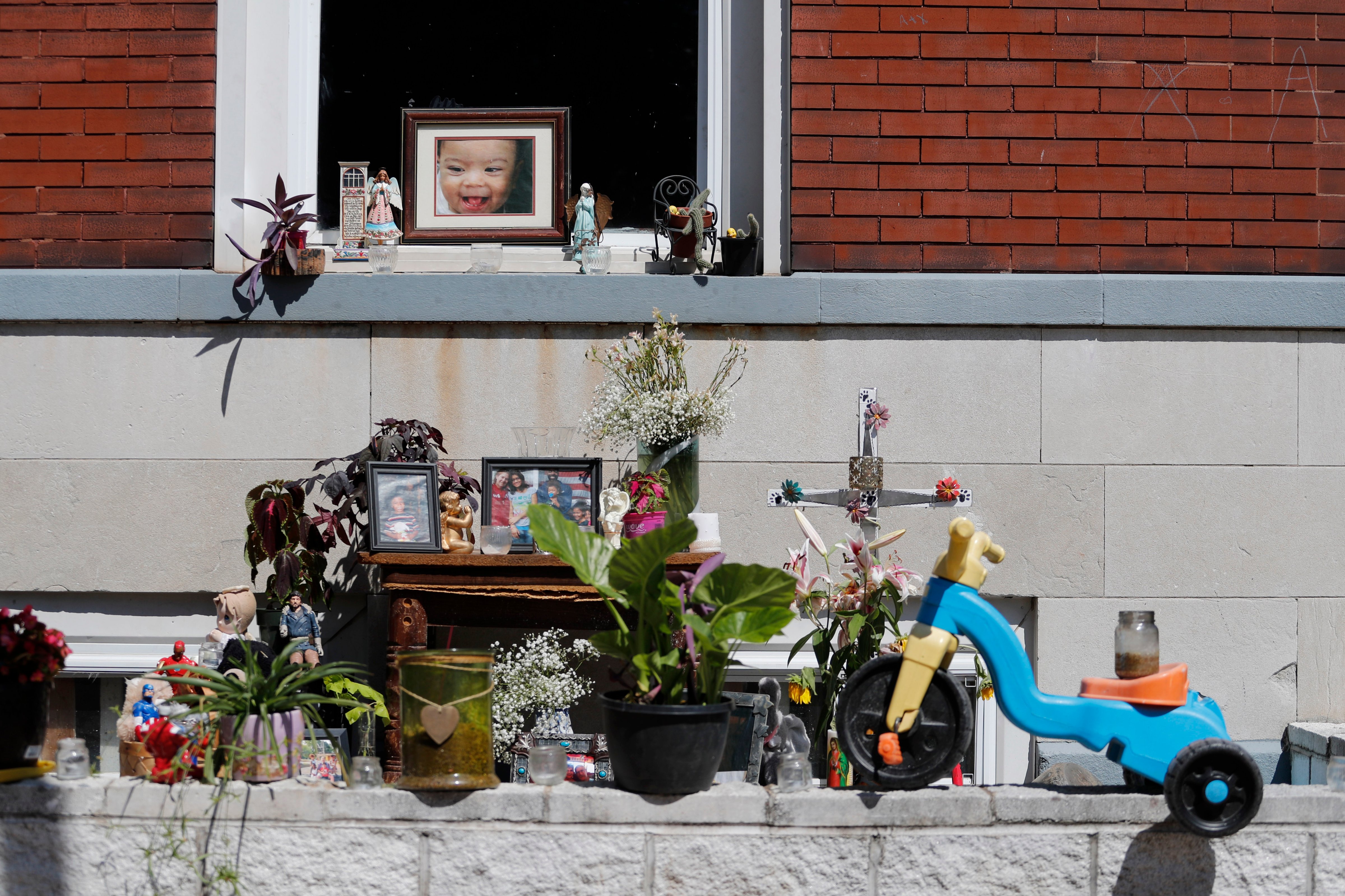In this Wednesday, Aug. 28, 2019 photo, a memorial to Xavier Usanga, 7, who was shot and killed earlier this month while playing with his sisters in their backyard, is seen outside his home in St. Louis. Civic leaders and parents alike are desperately seeking a way to curb the gun violence that has killed at least a dozen children in the high-crime city already this year. (Jeff Roberson—AP)