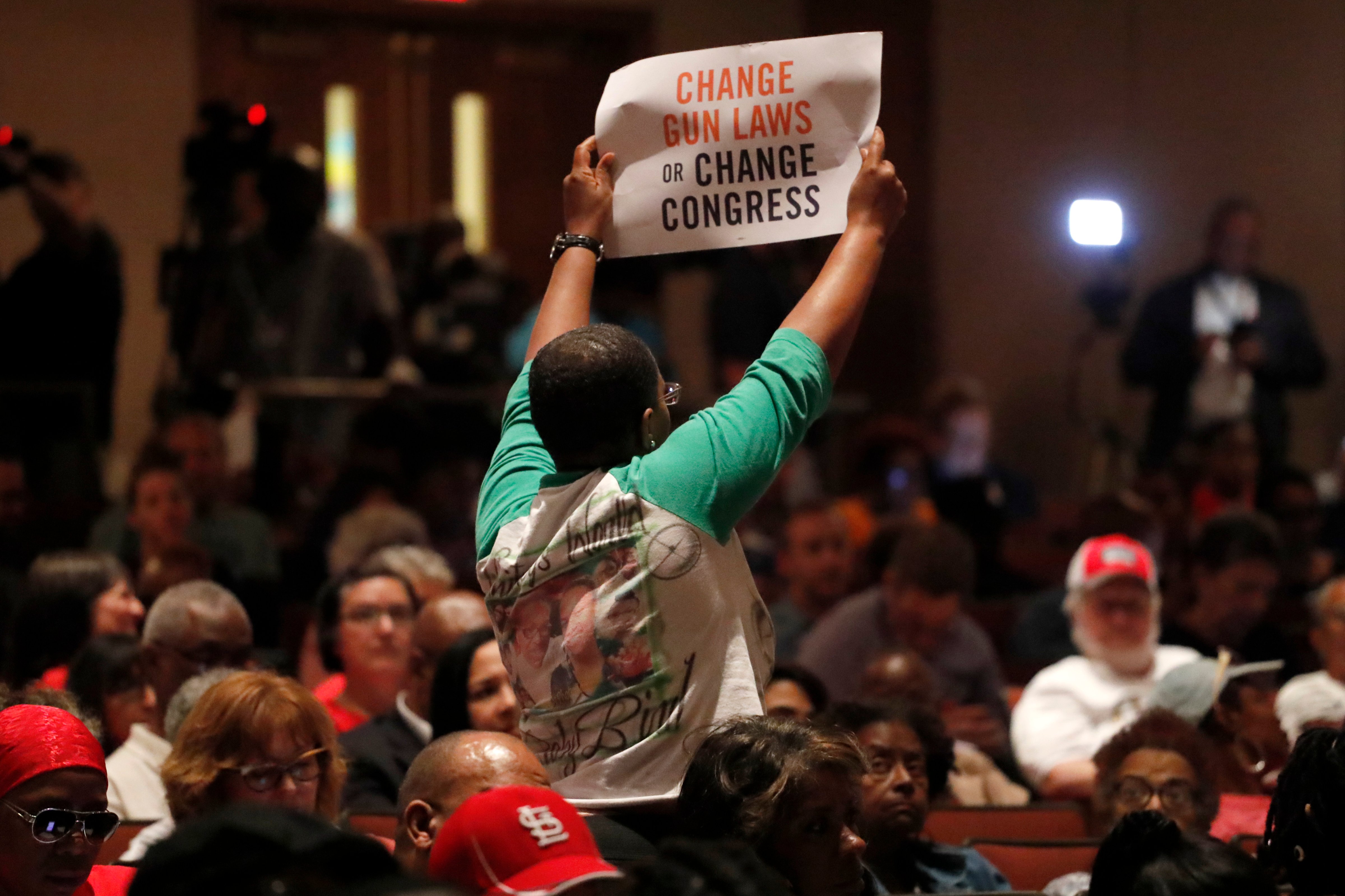 In this Wednesday, Aug. 28, 2019 photo, Erica Jones holds up a sign during a town hall to discuss the epidemic of gun violence and shocking number of children killed this summer in St. Louis. Jones, whose adult daughter was shot and killed in 2015, is like many parents desperately seeking a way to curb the gun violence that has killed at least a dozen children in the high-crime city already this year. (AP Photo/Jeff Roberson) (Jeff Roberson&mdash;AP)